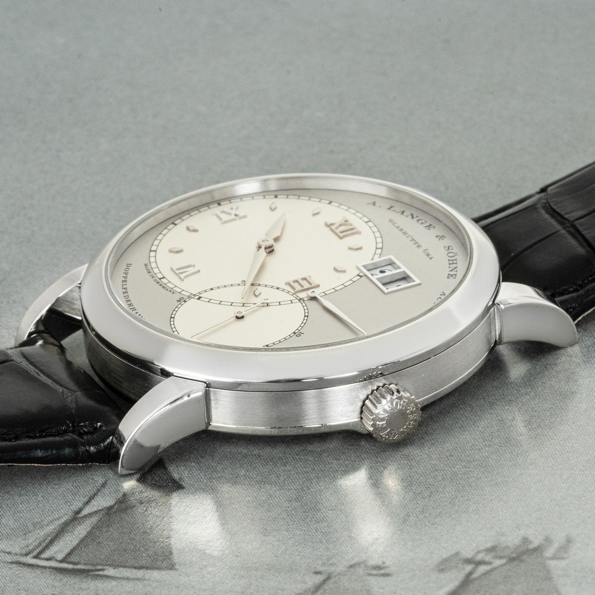 A platinum Grand Lange 1 by A. Lange & Sohne. Featuring a silver dial with a date display, power reserve indicator and a small seconds display.

The black Lange leather strap comes with a Lange platinum pin buckle. Fitted with sapphire crystal and a