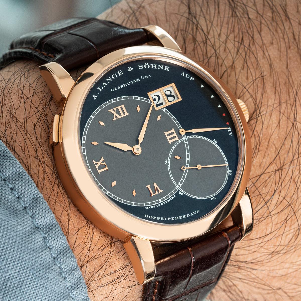 A rose gold Grand Lange 1 by A. Lange & Sohne. Featuring black and grey dials with a date display, power reserve indicator and a small seconds display.

The Lange brown leather strap comes with a Lange pin buckle in rose gold. Fitted with sapphire
