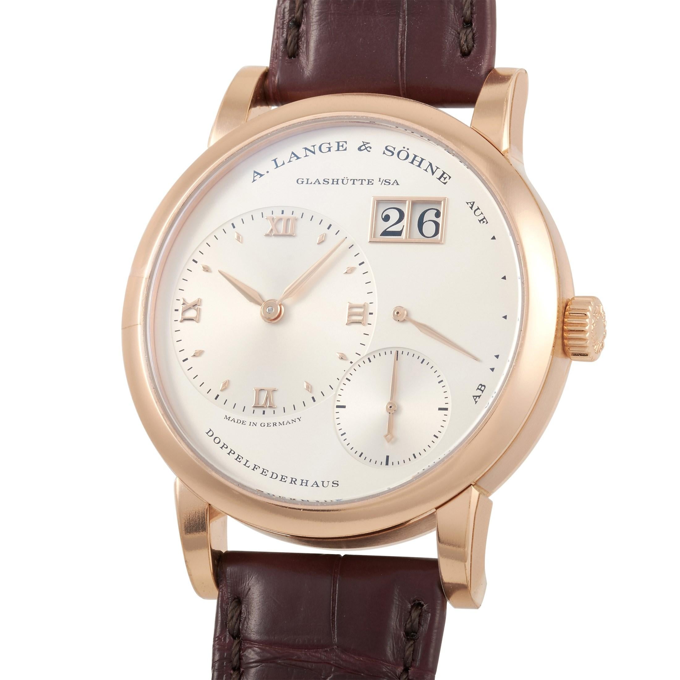 This A. Lange & Sohne Lange 1 38.5 mm 18K Rose Gold Watch, reference number 191.032, comes with an 18K rose gold case that measures 38.5 mm in diameter. The case is presented on a deep brown Alligator leather strap with tang closure. The transparent