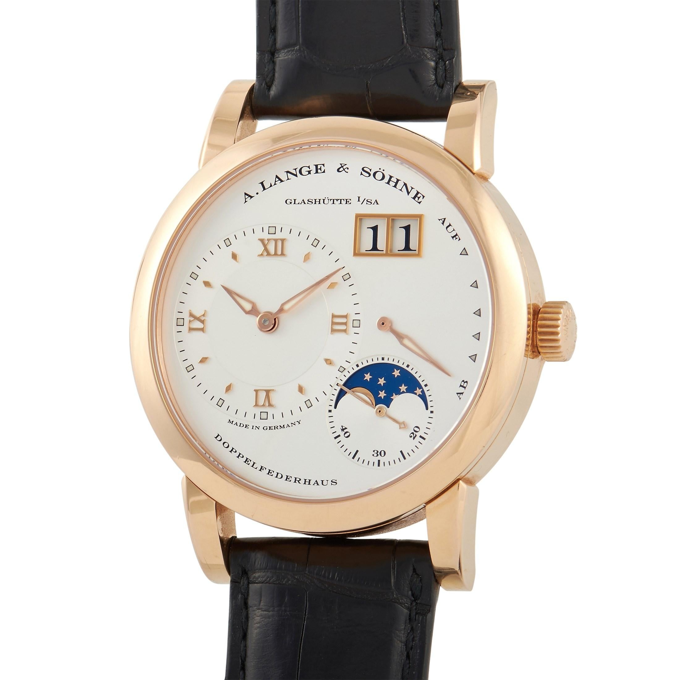 An exceptionally classy timepiece, the Lange 1 Moon Phase Rose Gold Watch 109.032 looks ever so elegant in its minimalist aesthetics. The 18K rose gold three-body case  measures 28.5mm in diameter and 10.3mm in thickness. The transparent case back