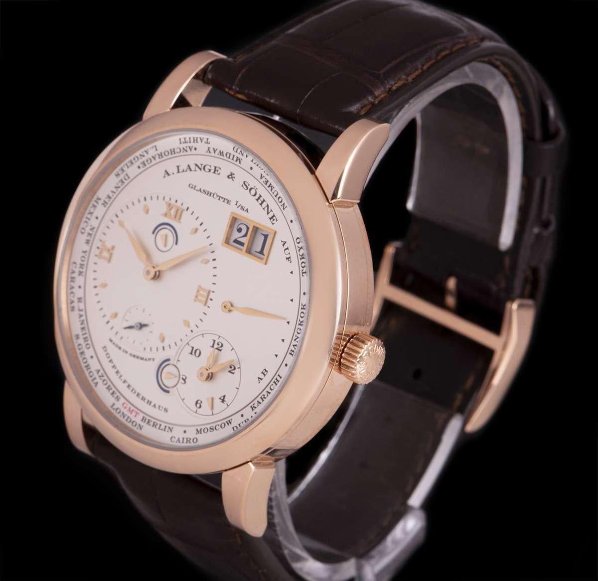 A 41.9 mm 18k Rose Gold Lange 1 Time Zone Gents Wristwatch, silver main dial - date at 1 0'clock, power reserve indicator at 3 0'clock, second time zone at 5 0'clock with day and night indicator, silver off-centred dial with applied hour markers and