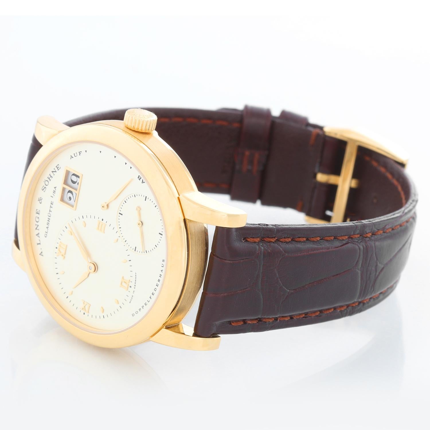 A. Lange & Sohne  Lange 1 Yellow Gold Men's Power Reserve Big Date Watch 101.022 - Manual winding. Yellow gold case with exposition back (37mm diameter). Silver dial with offset time dial with Roman numerals; sub seconds, power reserve indicator;