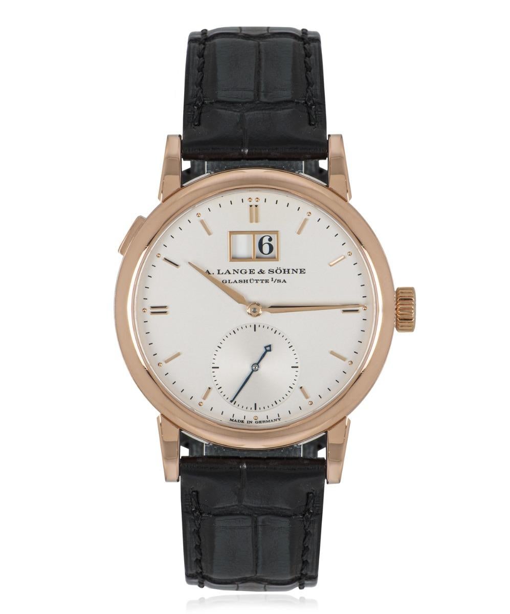 A stunning men's Saxonia wristwatch, 37mm in 18k rose gold, by A. Lange & Sohne. Featuring a distinctive silver dial, with rose gold applied hour markers and a small seconds sub dial. Complementing the dial is a smooth fixed rose gold bezel and an
