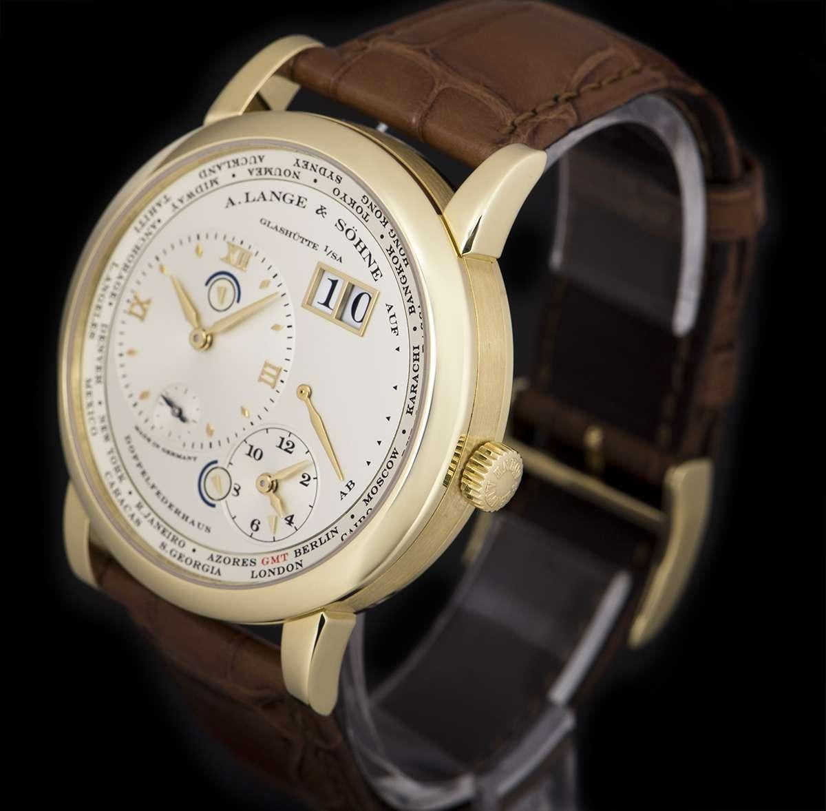 An 18k Yellow Gold Lange 1 Time Zone Gents Wristwatch, silver home time dial with applied hour markers, a small seconds display and a day/night indicator, date at 2 0'clock, power reserve indicator at 3 0'clock, second time zone dial at 5 0'clock