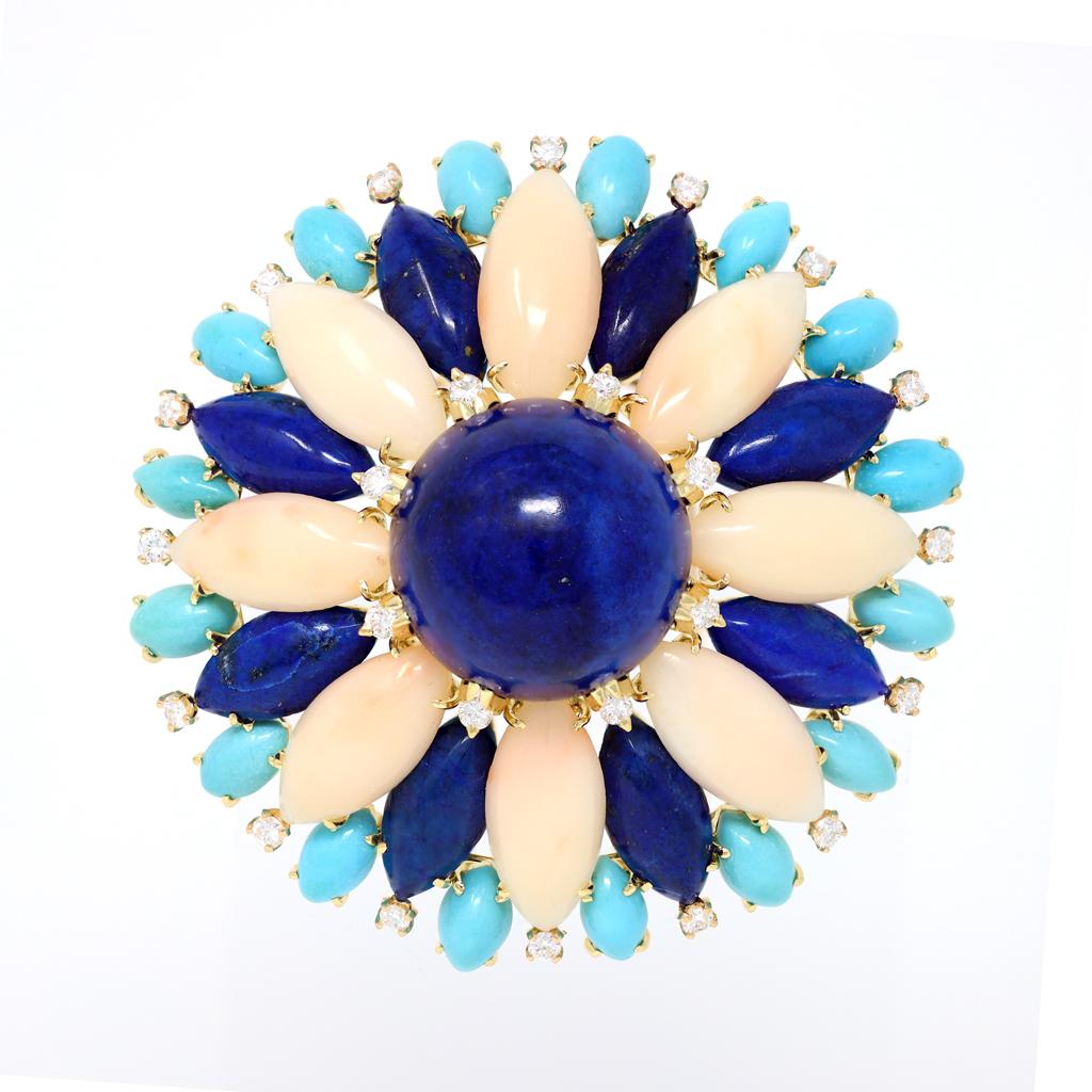 A very well made Suite composed of a necklace, a pendant/brooch and a matching pair of earrings. The ensemble features hard stone cabochons such as Turquoise Lapis lazuli and pink coral skillfully adorned with diamonds. The round dome shape of the