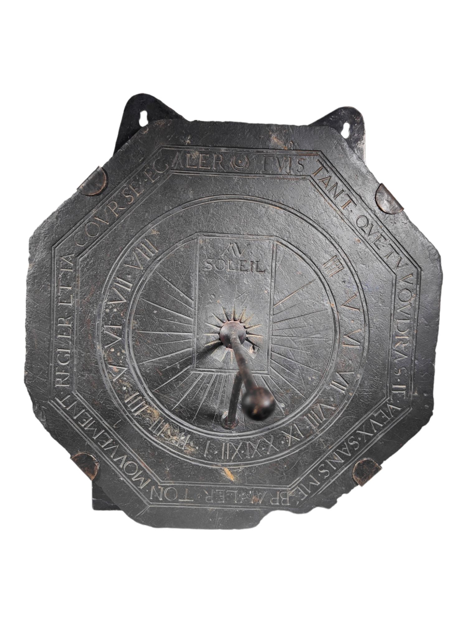 A Large 17th century French Slate Octagonal Sundial
With wrought iron gnomon and profusely engraved with latin letters.Size:39x39 cm.With latter hanging system.

The dial is set with a wrought iron gnomon which casts its shadow on the plate to