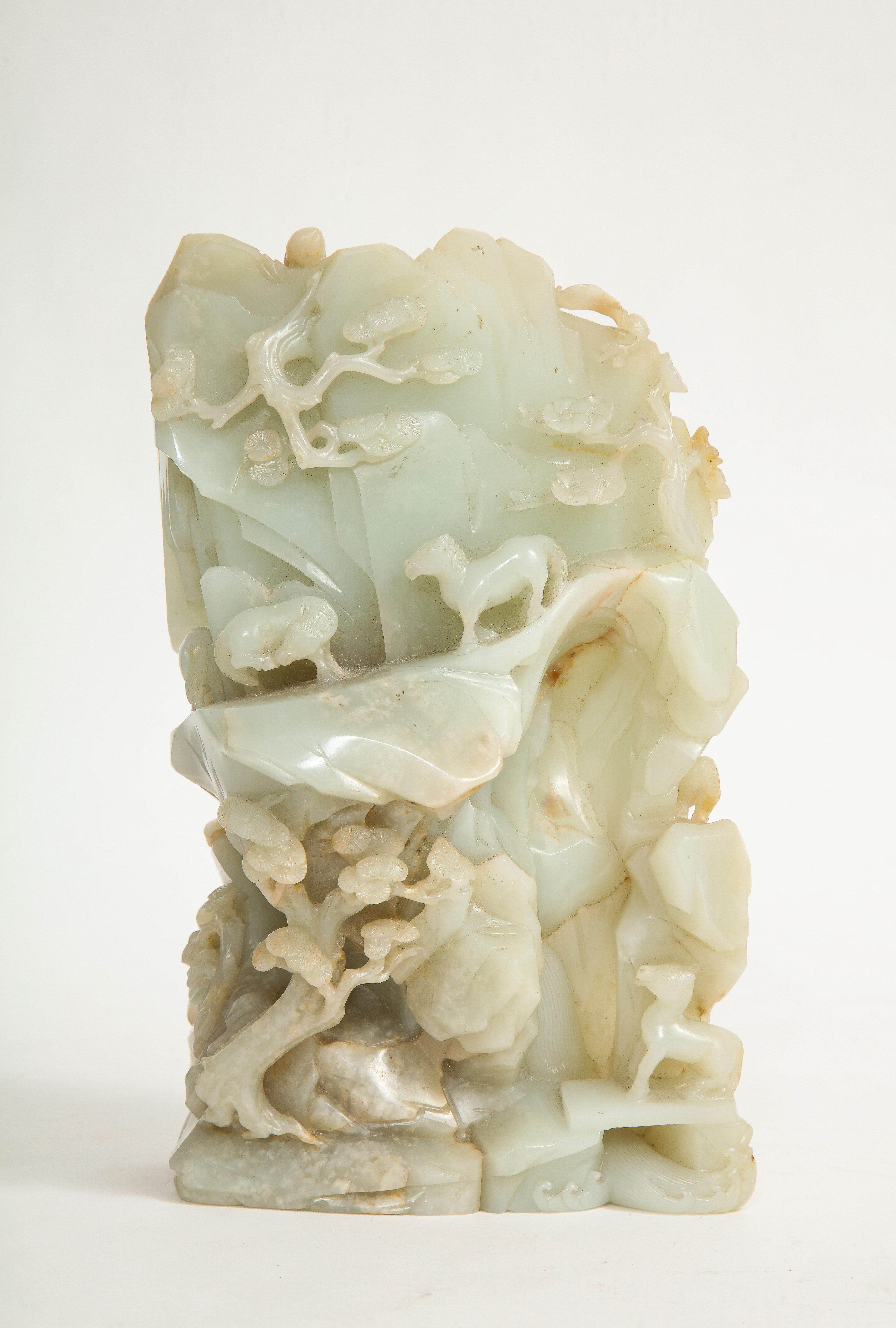 An incredible 18th/19th century Chinese Qing dynasty pale Celadon Jade high relief hand-carved mountain. With 360 degrees of carved decoration, this jade mountain is truly magnificent. The front is gorgeous with variable levels of relief depicting