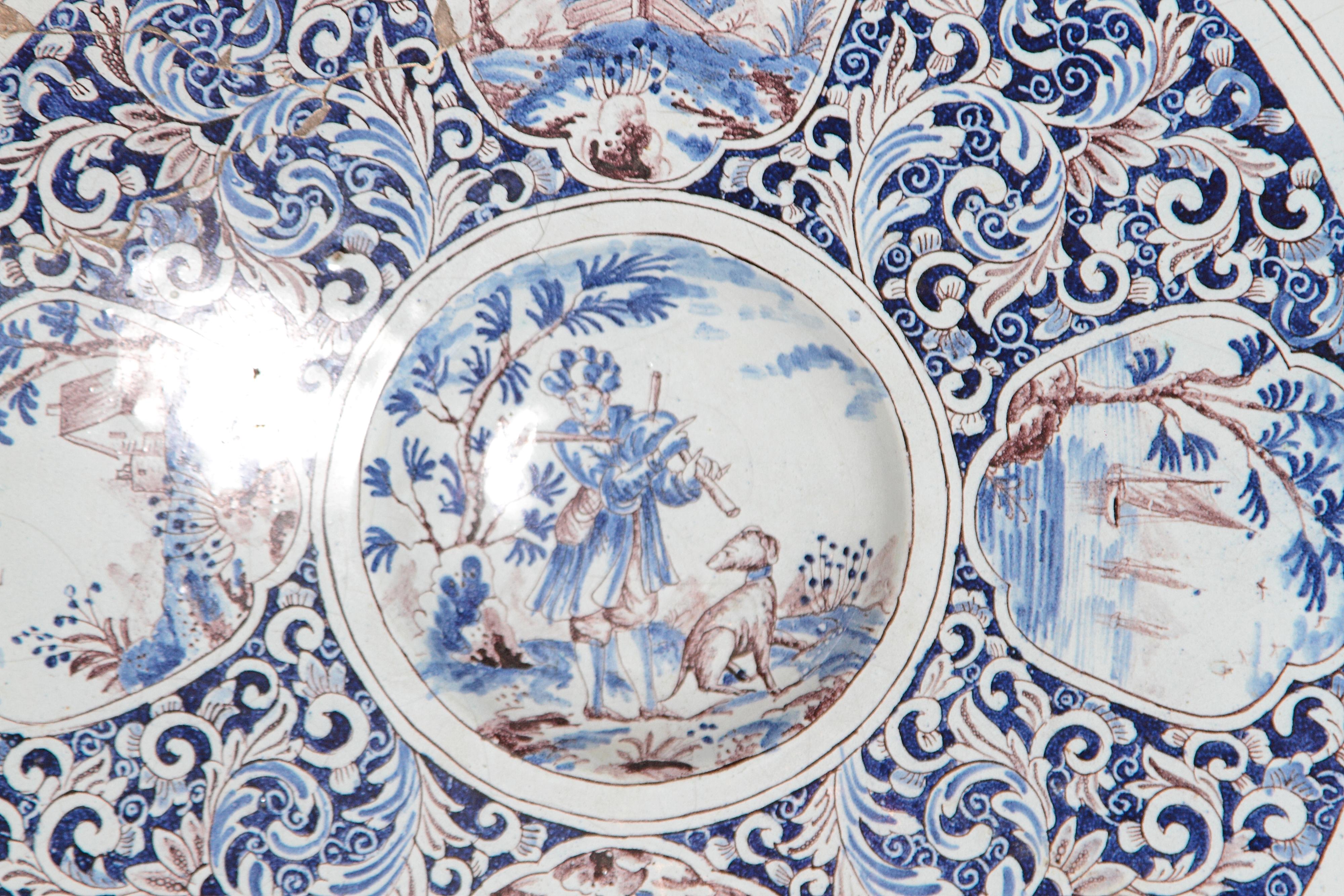 a large round Delft blue and white with brown faience charger with floral cartouches, Holland, 18th century

AS FOUND
old repair (SEE IMAGES) 
chips and worn placed to the edge of the plate