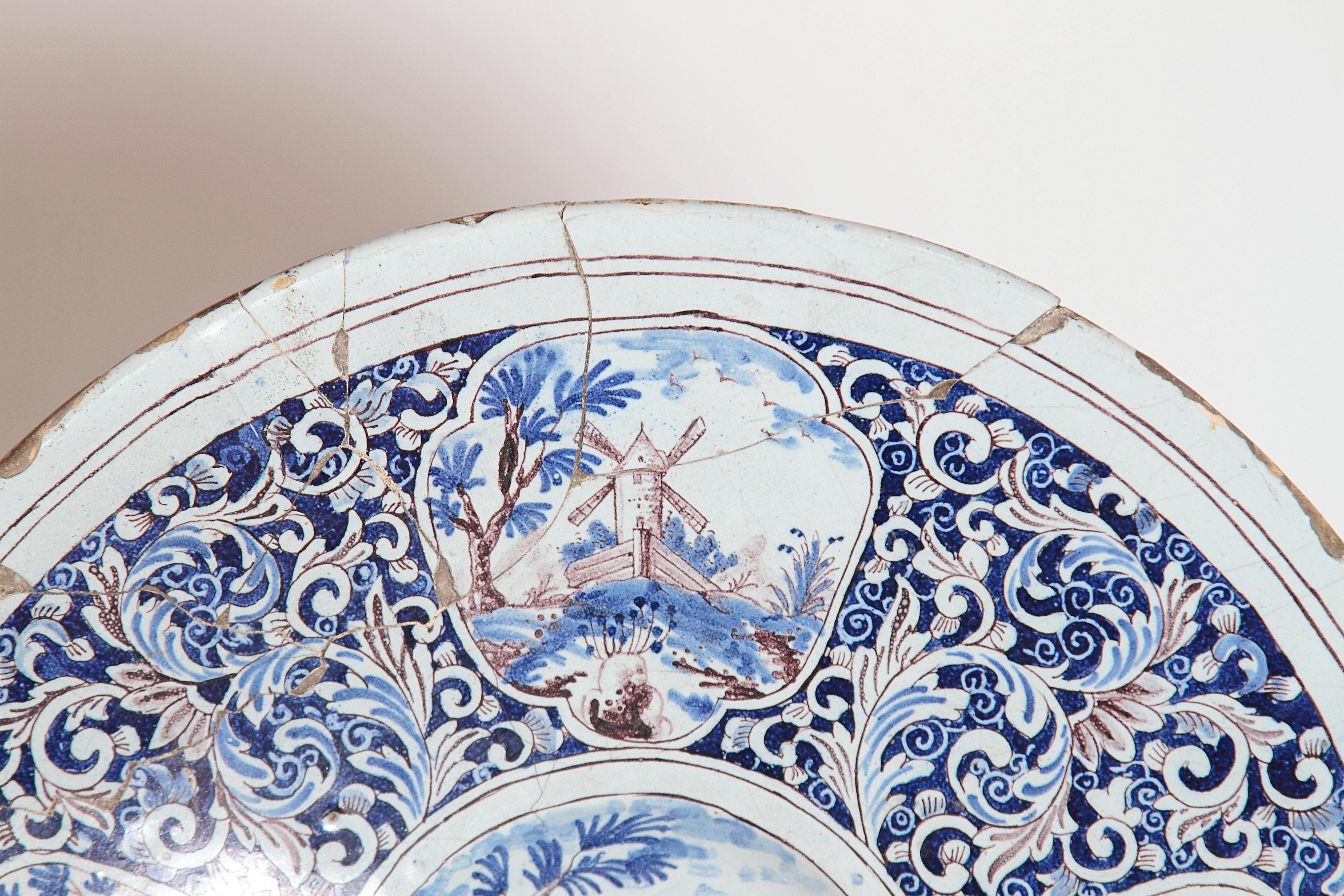 European A Large 18th Century Delft Faience Charger with Floral Cartouches For Sale