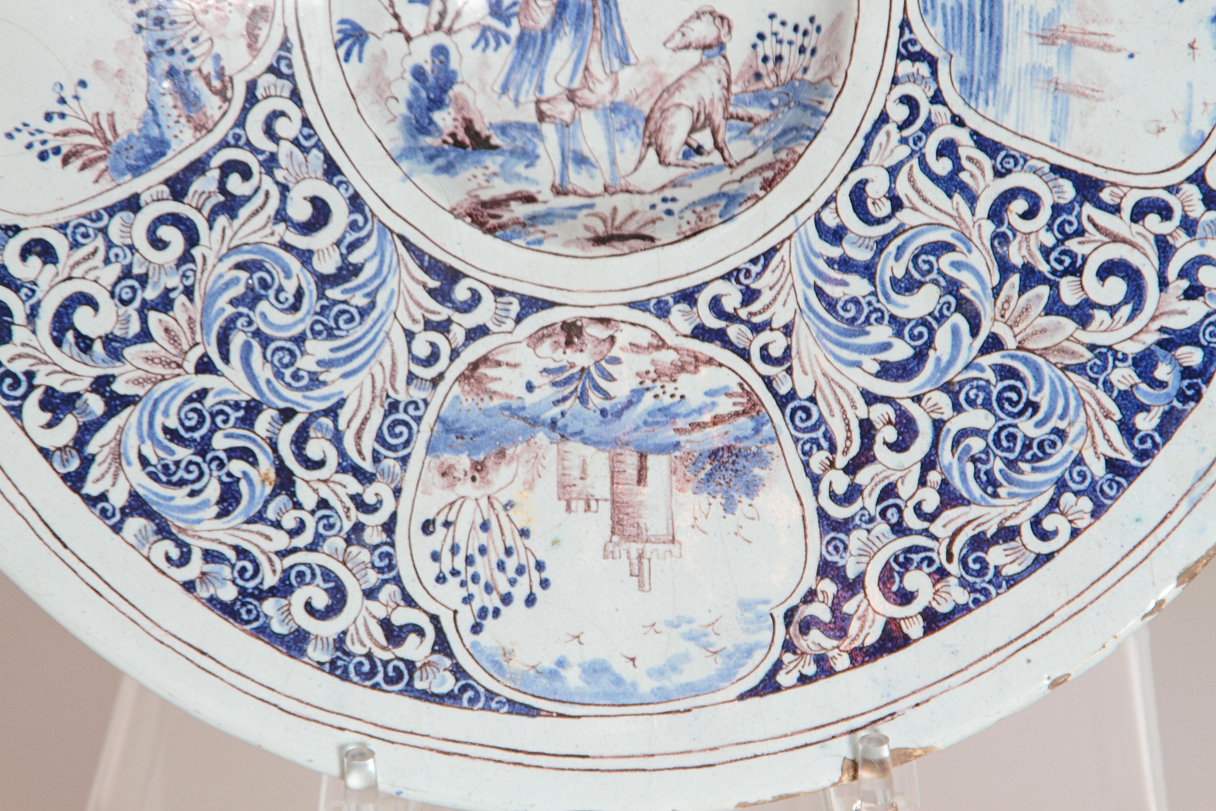 A Large 18th Century Delft Faience Charger with Floral Cartouches In Distressed Condition For Sale In Dallas, TX