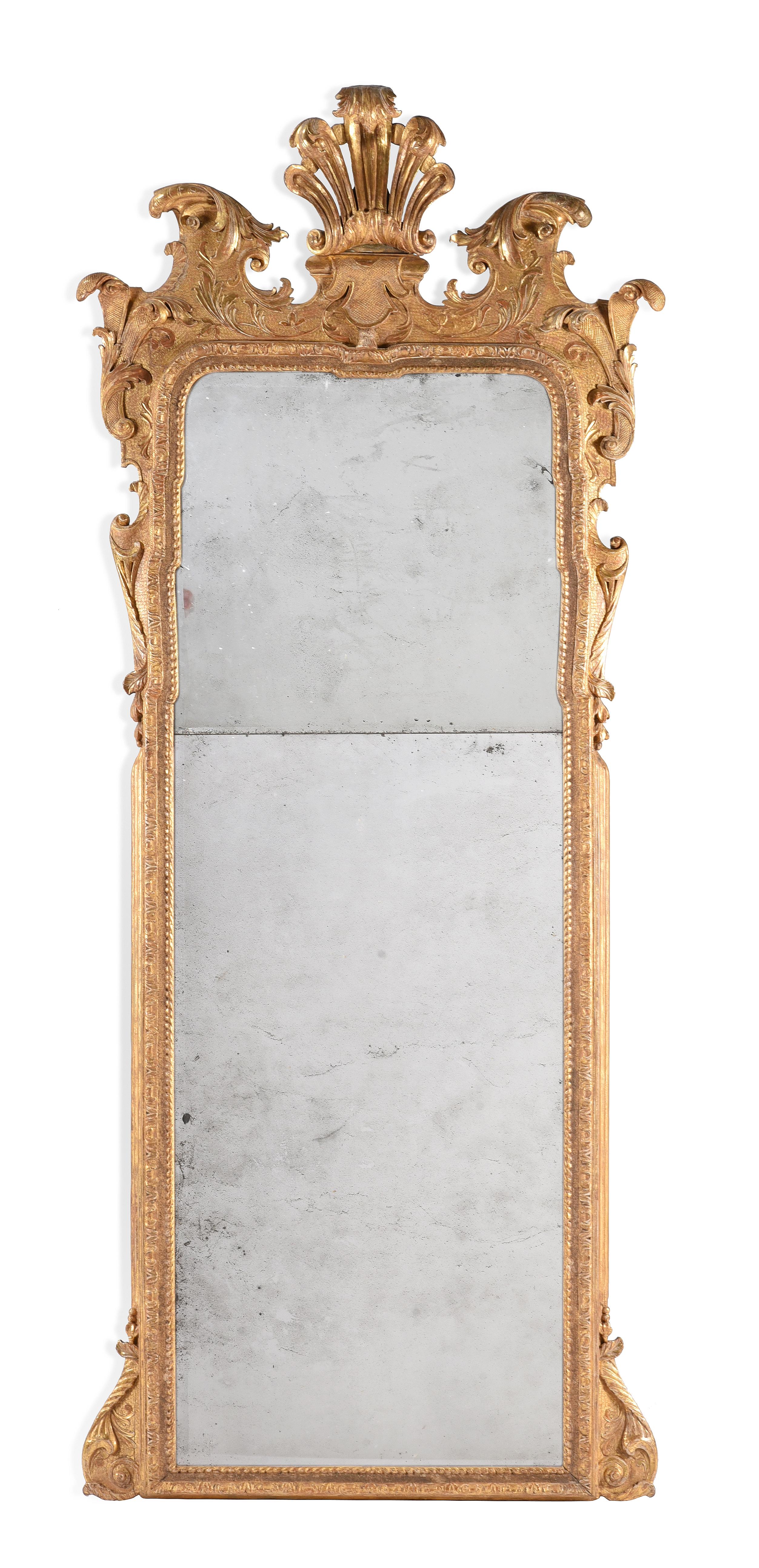 A Large and Important George I Gilt-Gesso Pier Glass, Attributed to John Belchier, Circa 1725. England.

Divided by the original arched and rectangular soft bevelled mirror plates within a gadrooned and foliate-carved border surmounted by an