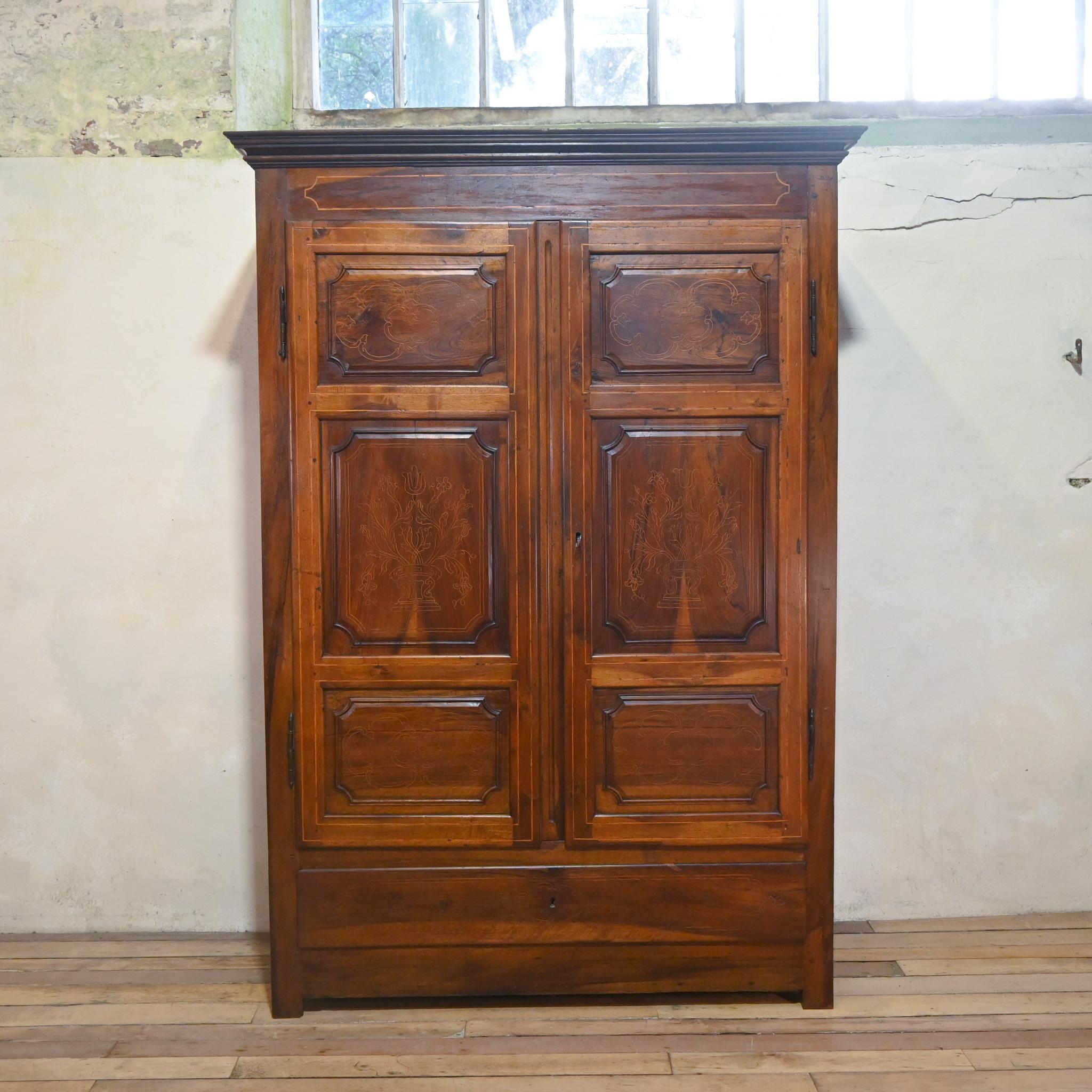 An extraordinary large scale 18th century Spanish walnut armoire from Catalonian. Demonstrating elegant boxwood inlay to the panelled doors and drawer. Displaying a simplistic design with subtle detailing, lending itself to many interiors. The