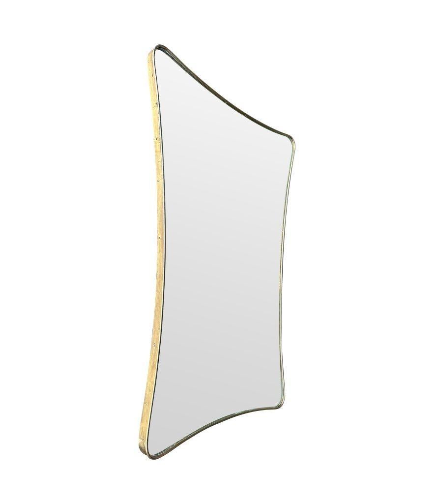 A large 1950s orignal Italian shield mirror with lovely shaped solid brass frame and orignal mirror plate and solid wood frame. Width at the base 61cm