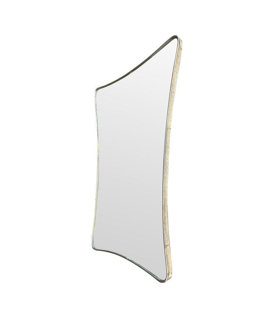 A large 1950s orignal Italian shield mirror with solid brass frame. In Good Condition For Sale In London, GB