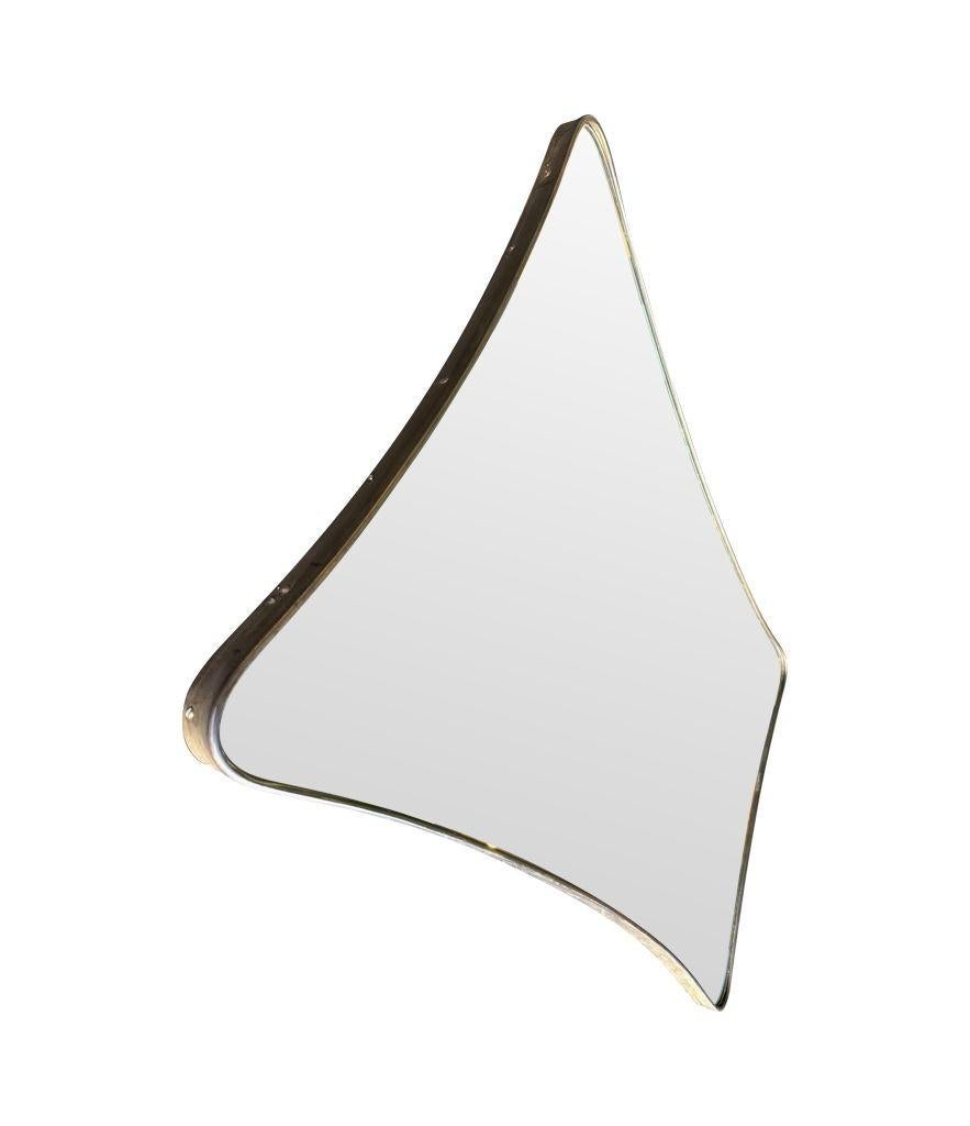 Mid-20th Century A large 1950s orignal Italian shield mirror with solid brass frame. For Sale