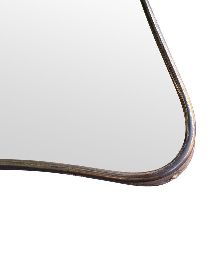 Brass A large 1950s orignal Italian shield mirror with solid brass frame. For Sale