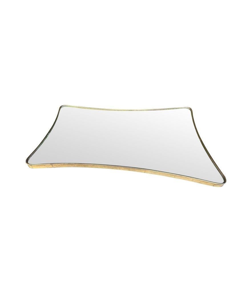 A large 1950s orignal Italian shield mirror with solid brass frame. For Sale 1