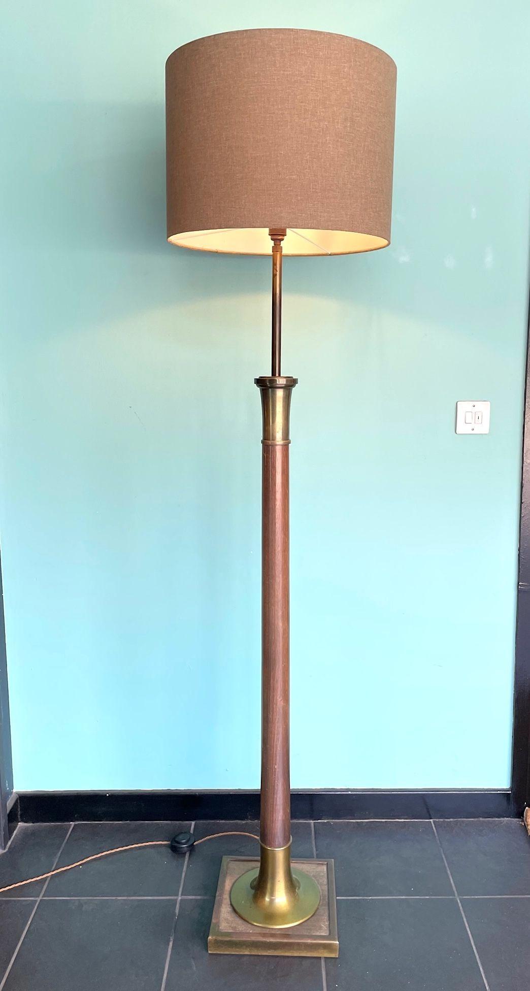 A large 1950s Spanish wooden and brass floor lamp re wired with new brass fittings, antique gold cord flex and foot switch. With new bespoke natural linen drum shade.