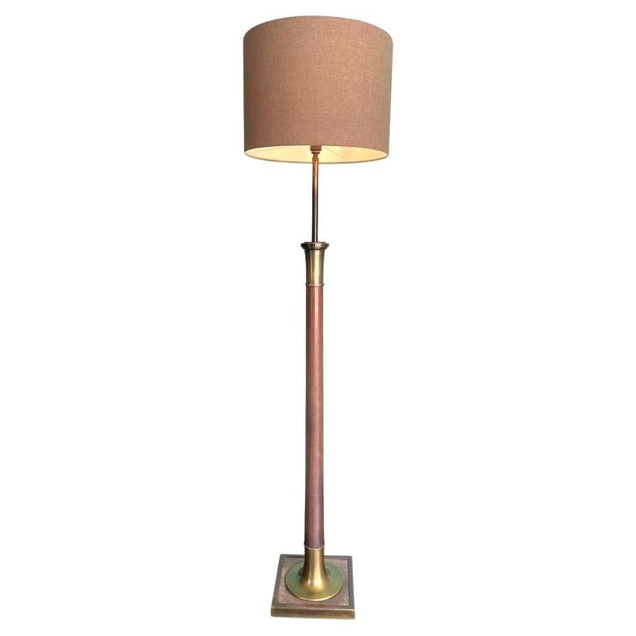 A large 1950s Spanish wooden and brass floor lamp with natural linen drum shade