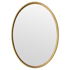 A large 1970s Italian brass framed oval mirror with bronzed mirror plate