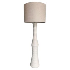 A large 1970s Italian white ribbed ceramic floor lamp with natural linen shade