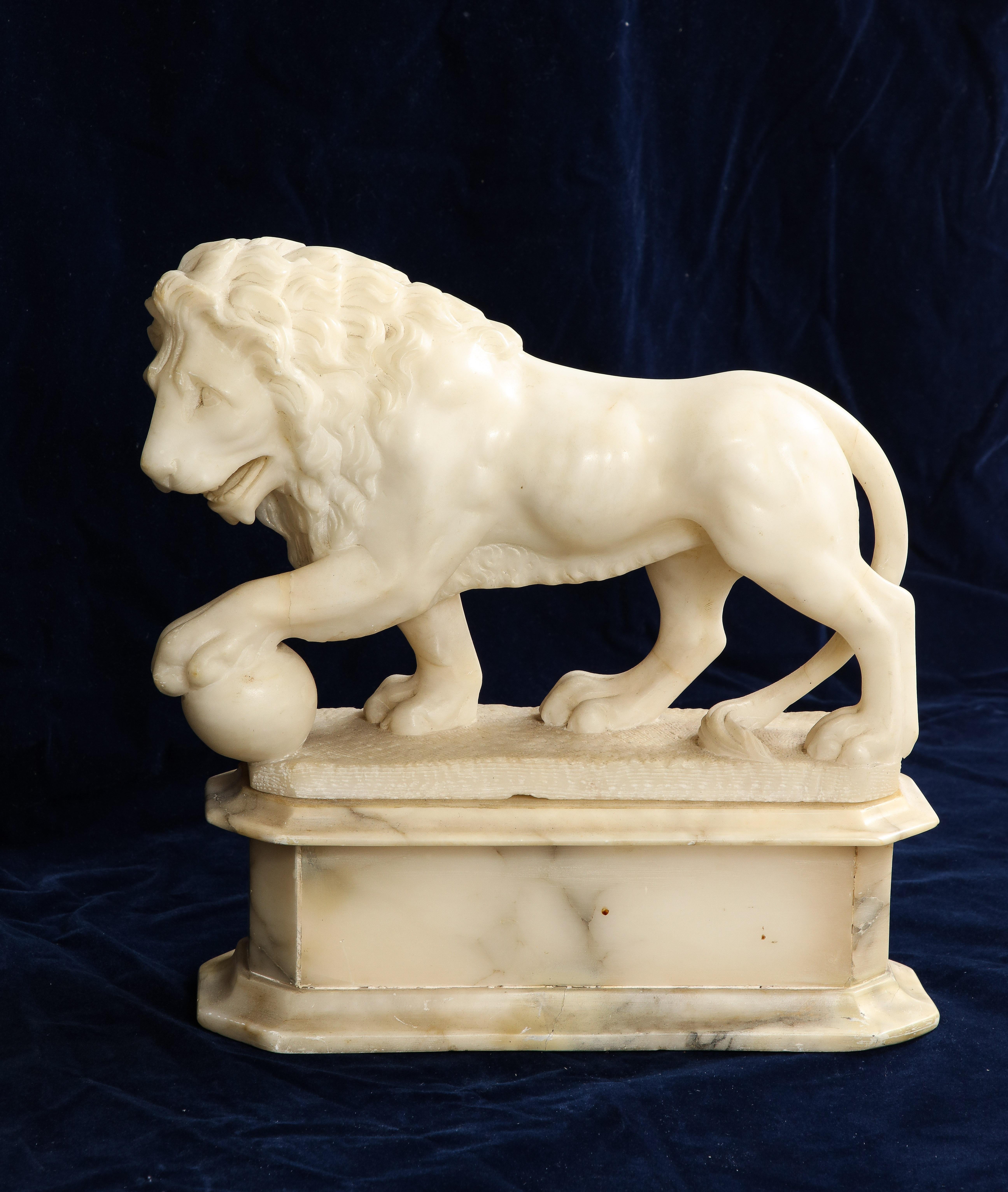 A large 19th C. Carrara marble Lion with Orb on stand after Pietro Simoni Da Barga's famous Renaissance Medici Lions, which are modeled after the antique pair of statuesque Marble Lions balancing on orbs. The lion is finely chiseled and hand-carved