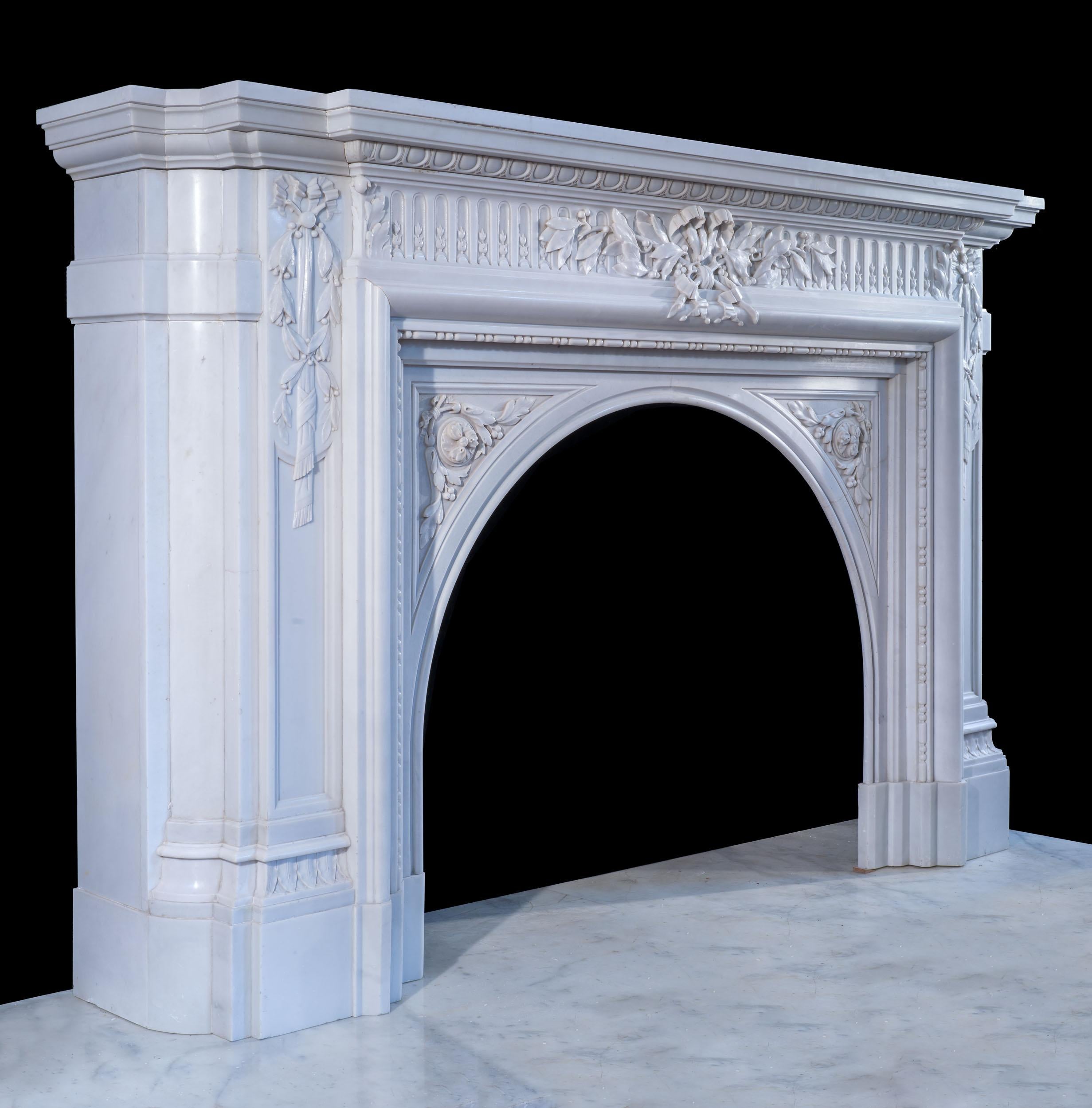 A very fine and grand 19th century arched fireplace in a pure white Bianco P marble. Perhaps the best feature of this fireplace is the exceptional carving; the moulded shelf rests on an underfrieze carved with an egg and dart moulding, which in turn