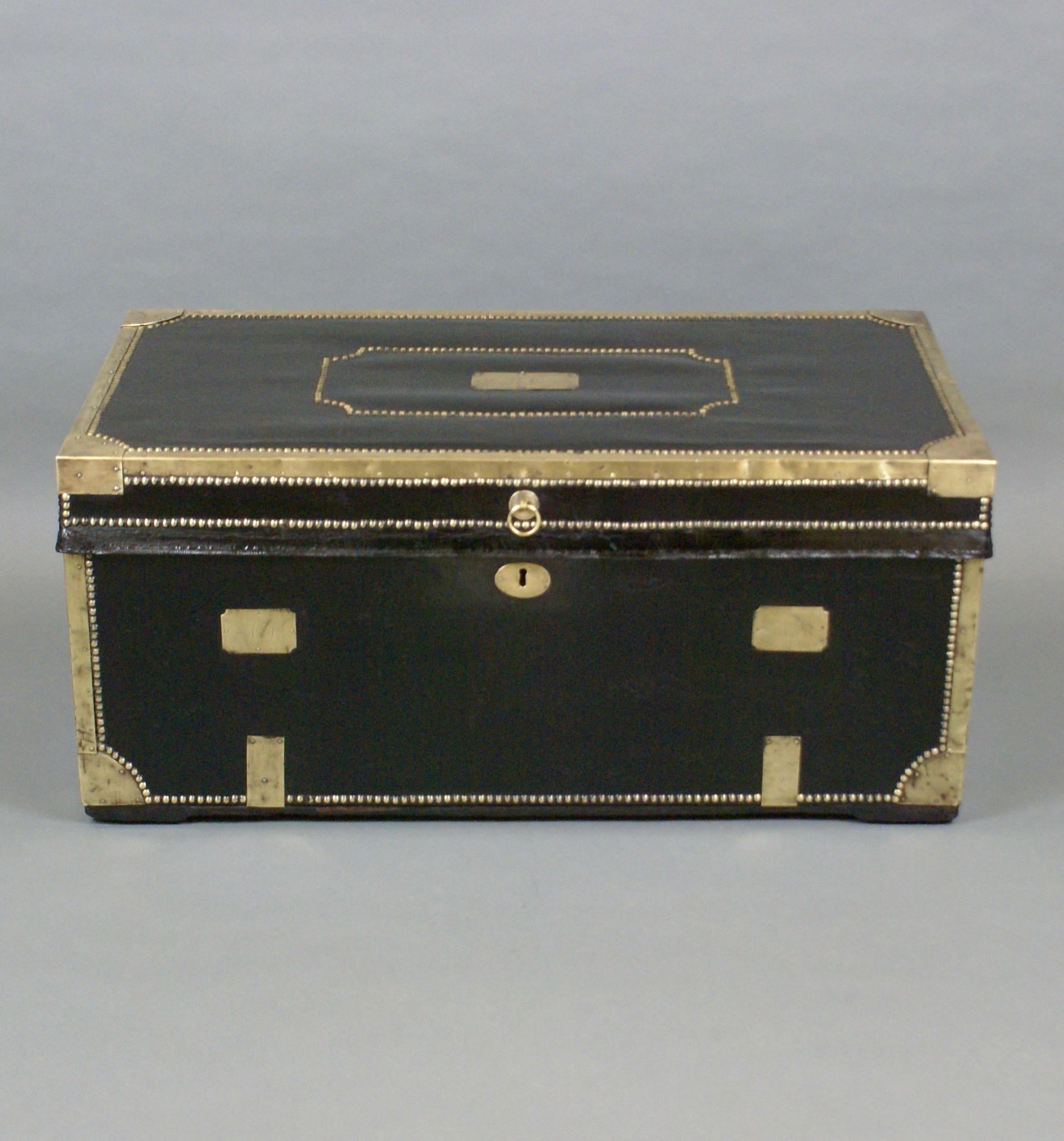 A large 19th century China trade traveling trunk. The black leather over solid camphor-wood, brass edged and double studded, with three initialed brass plates. In good and original condition throughout.
 