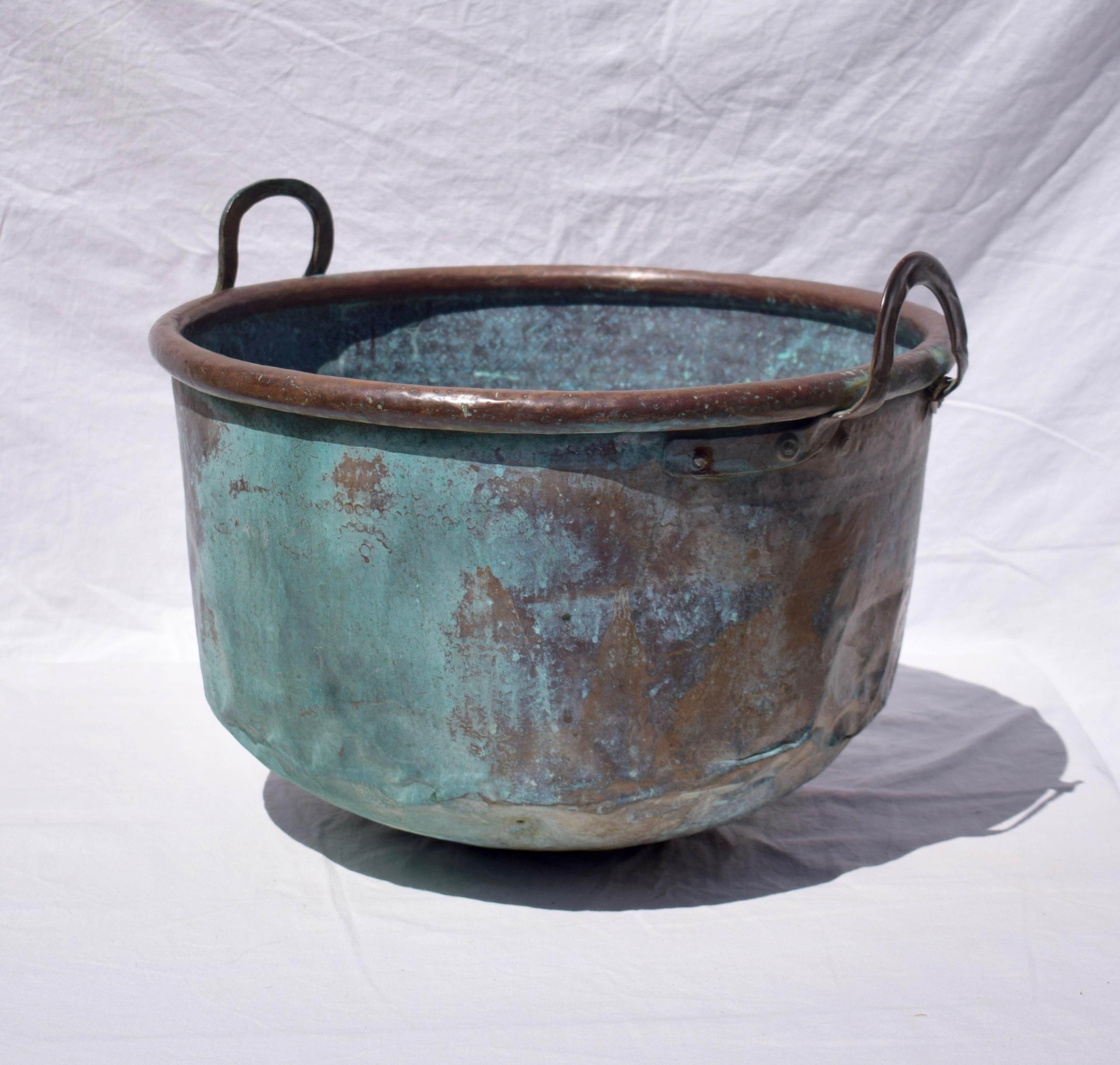 This large French farmhouse copper cauldron was probably made around 1850 and is from the Second Empire Period. The copper has a rich Verdigris patina colouration that enhances the object aesthetically. It is unique and unusual. The cauldron would