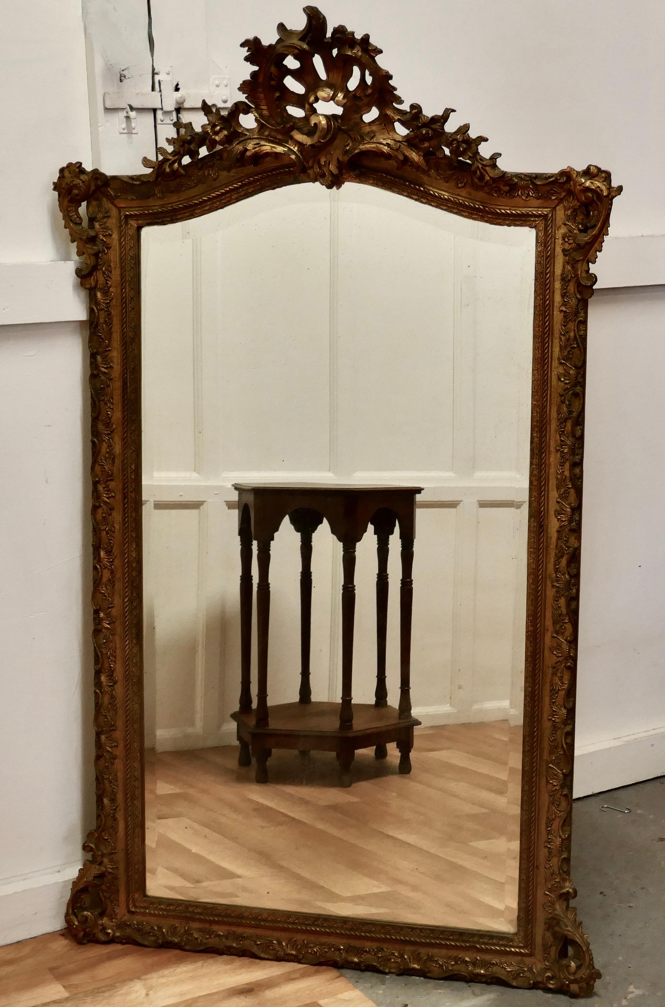A large 19th century french gilt wall mirror.

This mirror has a beautiful gilt and gesso frame the carved frame has darkened slightly with age and has rich bright gold leaf showing through
The 4” wide moulded frame is decorated and has an
