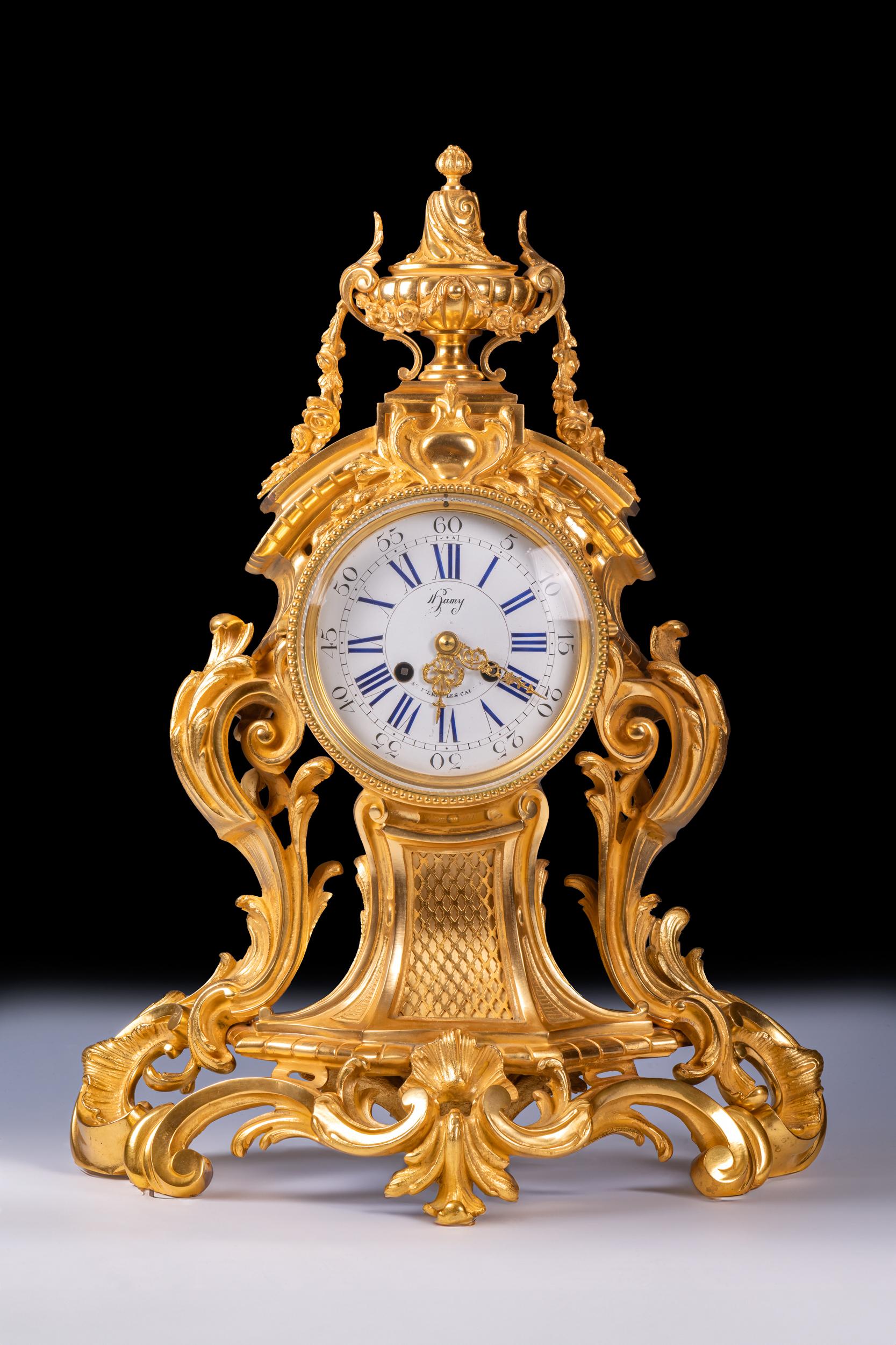 A fine 19th century and substantial ormolu clock, of Rococo balloon form, sweeping acanthus swags, scrolls and floral flourishes, which is topped by classical cornucopias. The clock features a circular white enamel dial which is inscribed with both