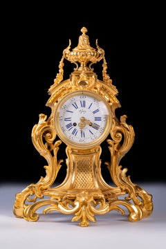 Grande horloge de cheminée française du 19ème siècle en bronze doré de style rococo