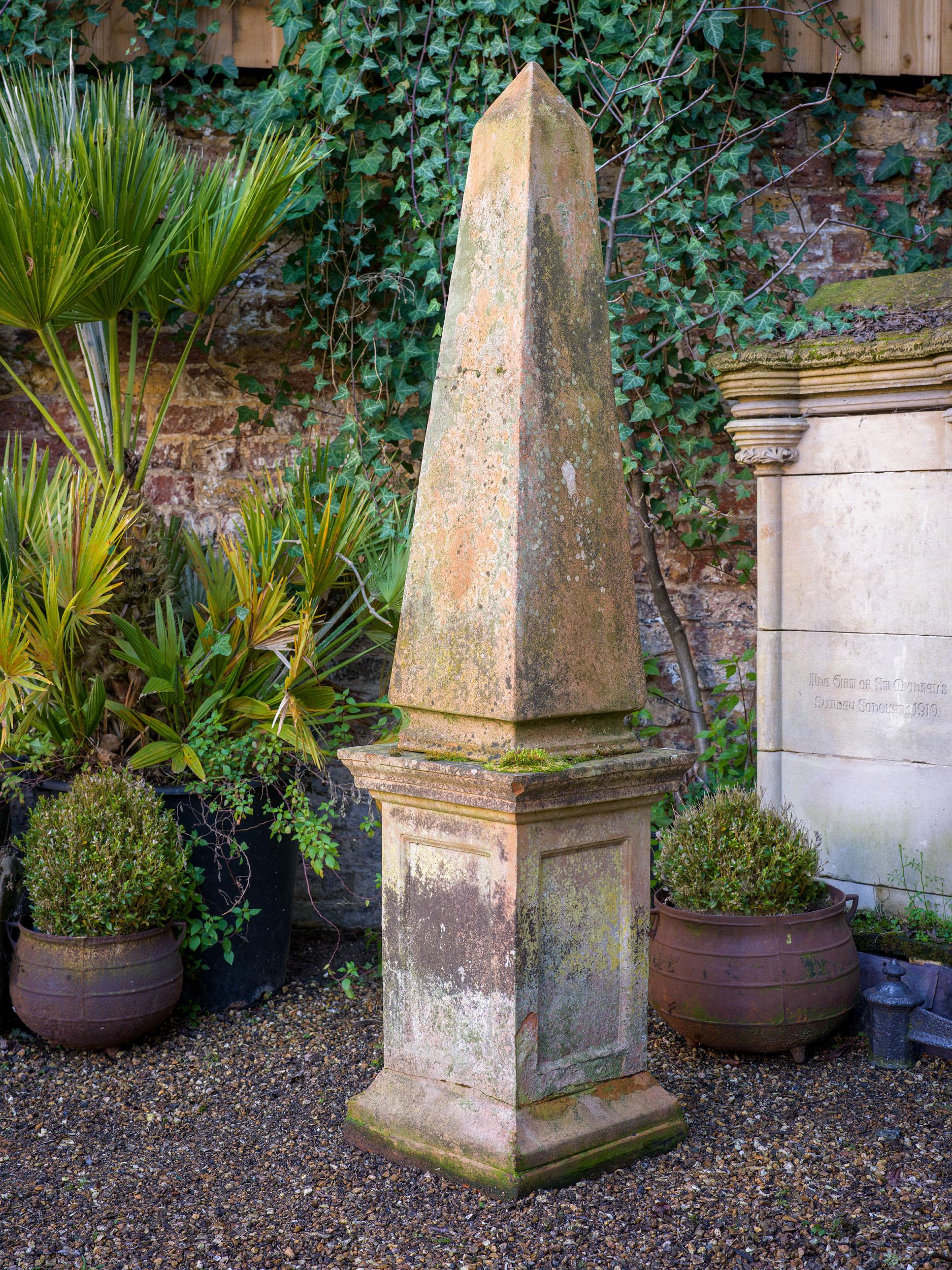 A large 19th century obelisk in a buff terracotta, with its original plinth. The surface of the obelisk has developed a beautiful patina, and it would make the most perfect garden centrepiece.

English, mid-19th century.

