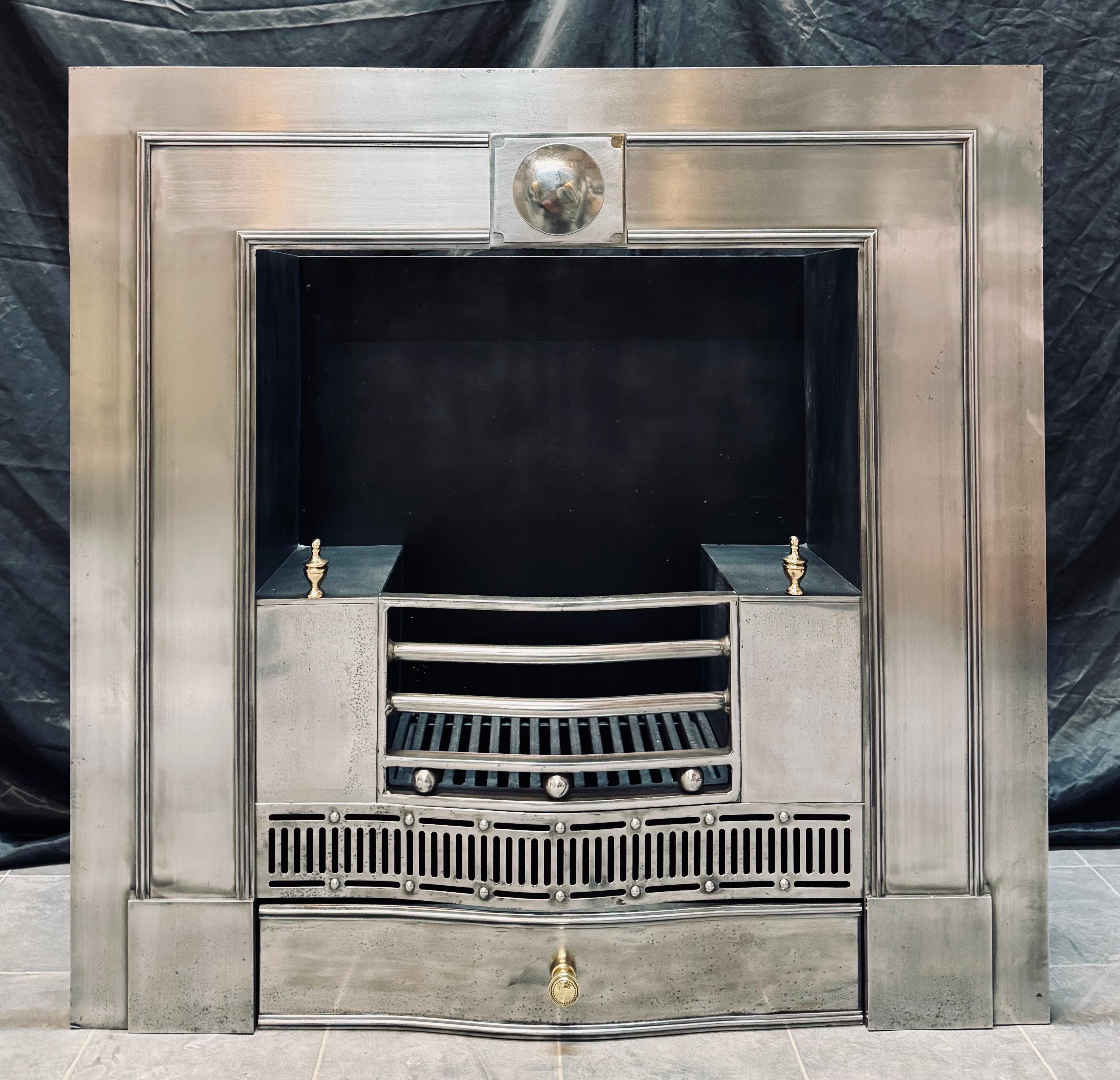 A larger than normal 19th Century Georgian manner polished steel fireplace insert. A generous polished outer plate with an applied raised lambs tongue moulding, encompassing a central tablet with a projecting polished disc.
The four bared shaped