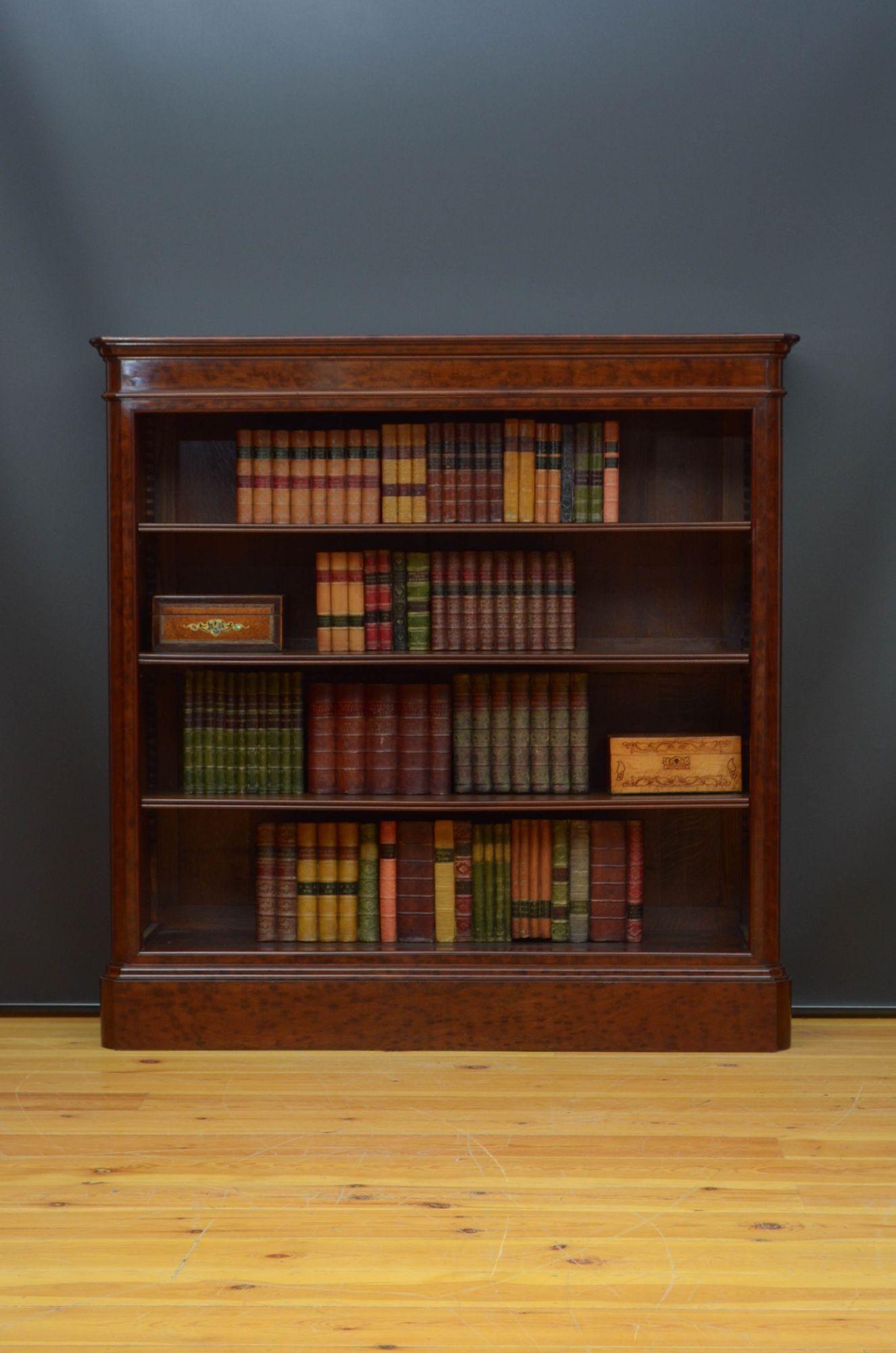 Sn5410 Superb quality XIXth century open bookcase in plum pudding mahogany, having oversailing top with outstanding mahogany grain above three height adjustable shelves flanked by rounded corners, all standing on moulded plinth base. This antique