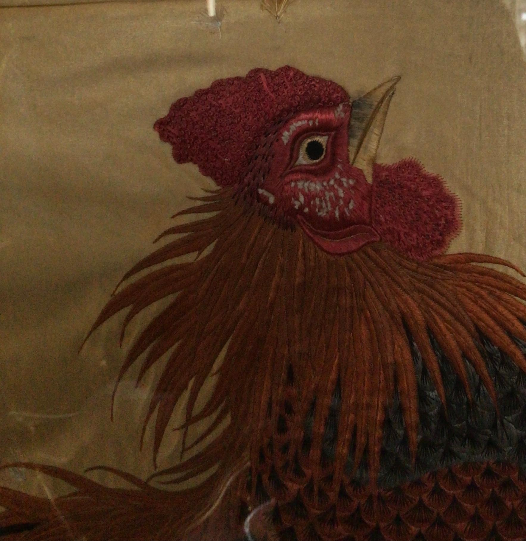 A large 19th century oriental silk embroidered panel, ‘A pair of fighting cocks’, framed.