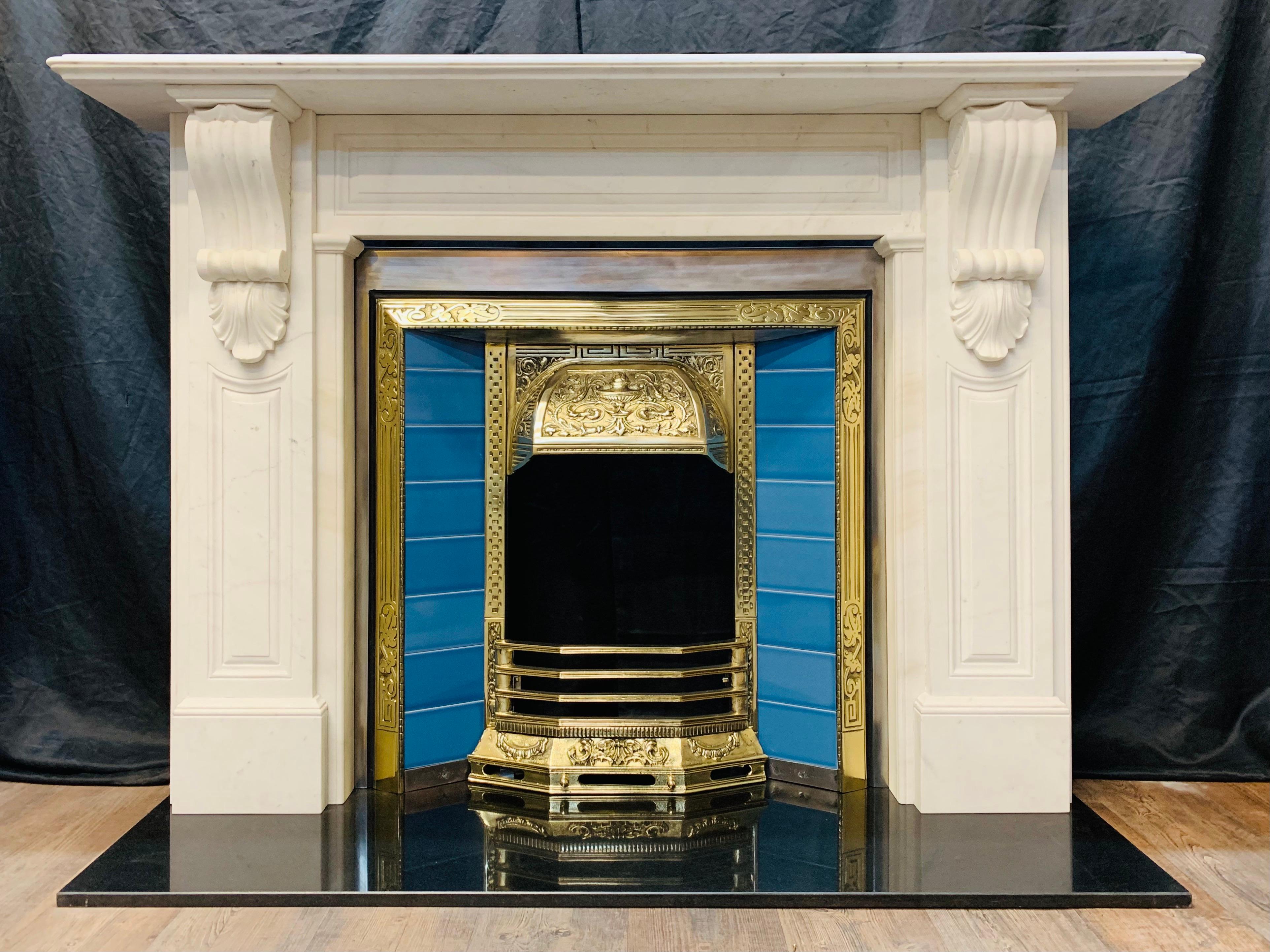 A large and impressive 19th century style Statuary marble corbel fireplace surround. A deep shelf with ovolo edge moulding rests above a recessed cushion panelled frieze, flanked by stepped jambs with further recessed panelling hosting a pair of