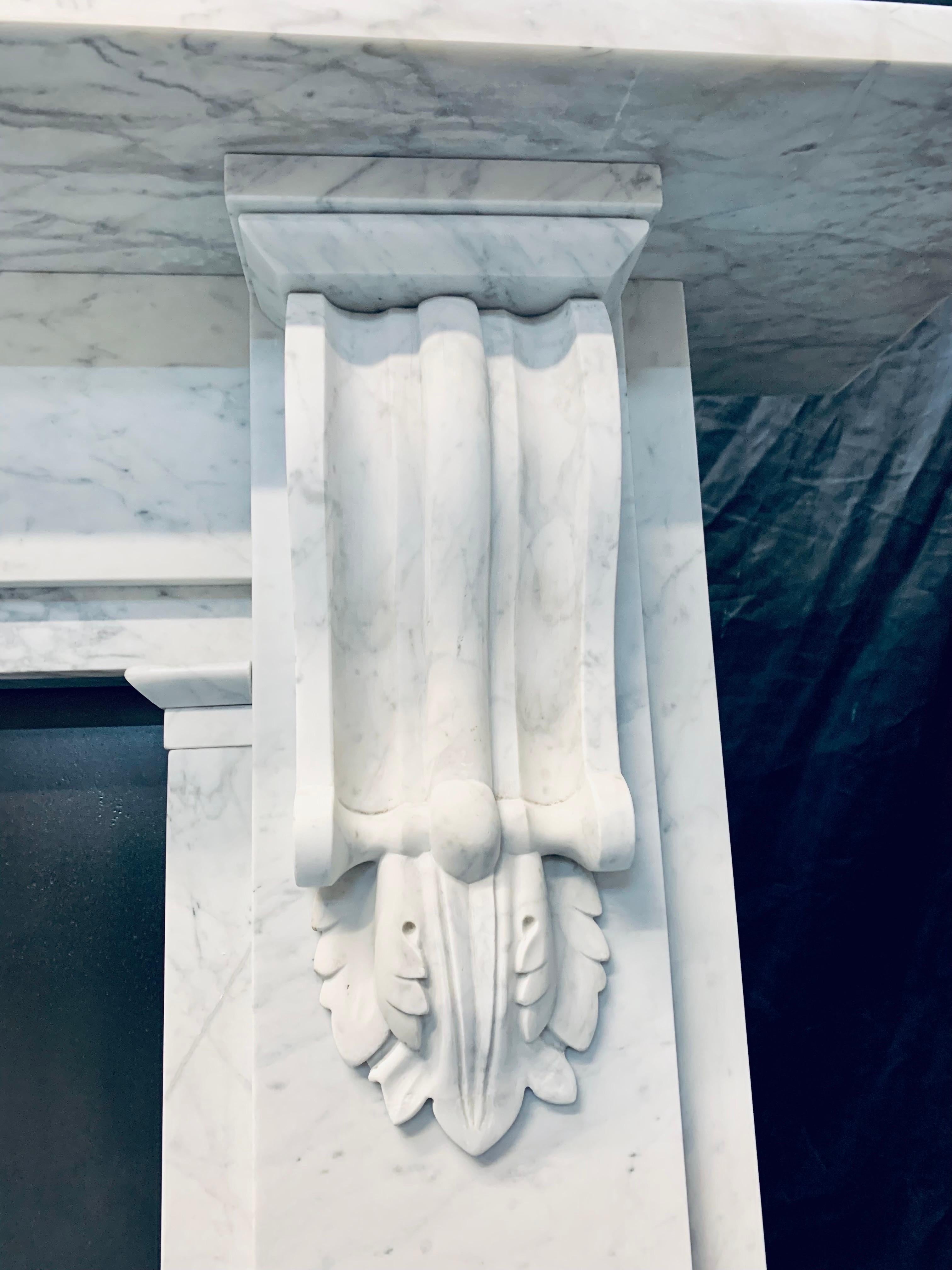 Carved A Large 19th Century Victorian Carrara Marble Corbeled Fireplace Surround.  For Sale