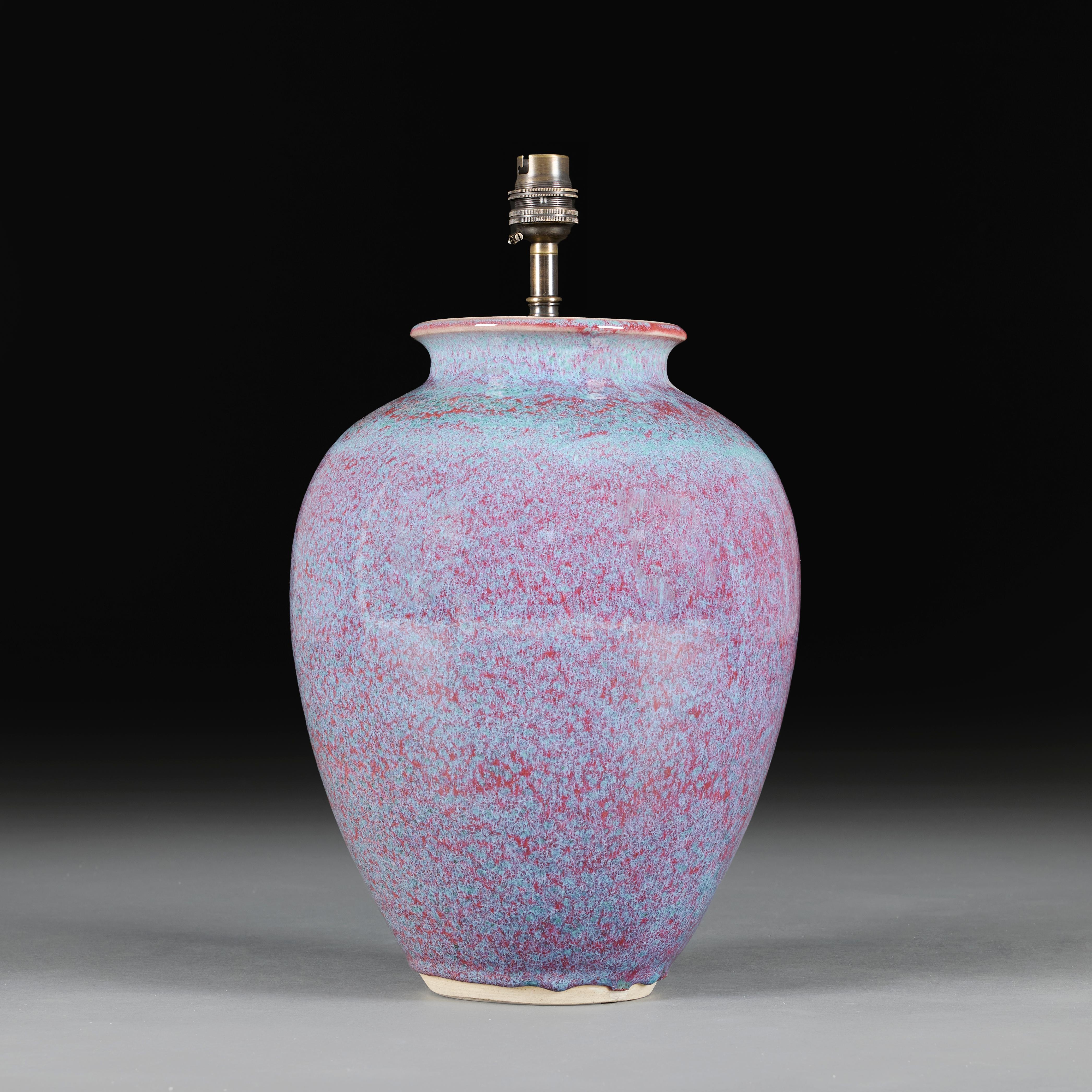 China, circa 1940
A mid twentieth century Chinese flambé vase, with blue and purple hues throughout the glaze, now converted as a lamp.

Height of vase              36.00cm
Height with shade      65.00cm
Diameter of body        25.00cm

Please