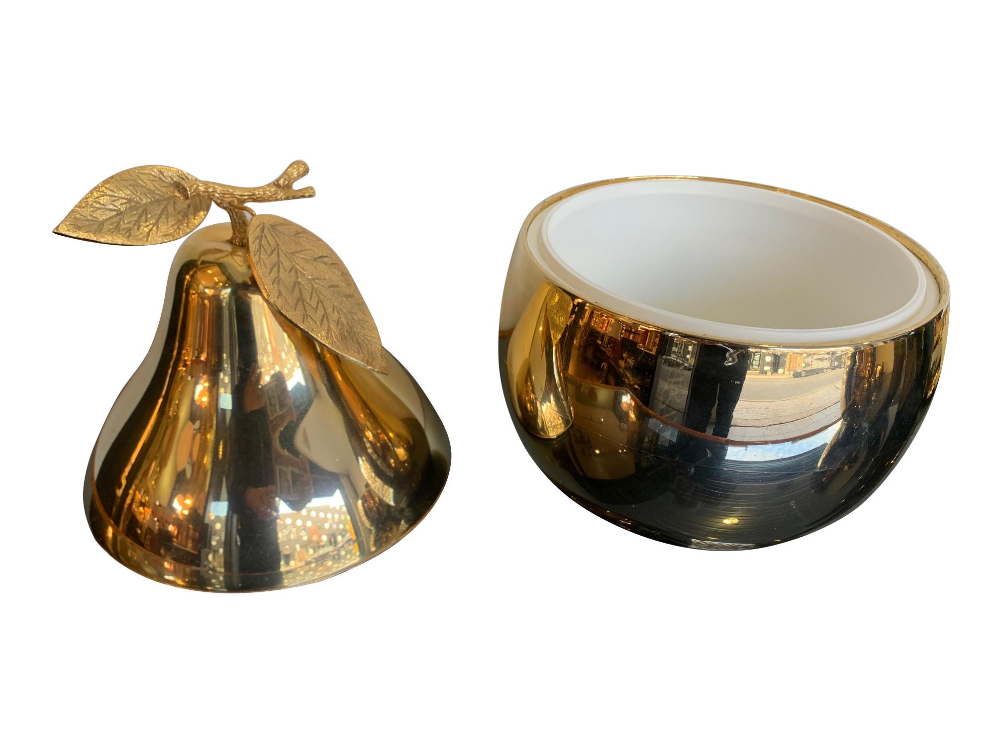 A large 24-carat gold-plated pear shaped ice bucket with detailed leaf and stem handle. Made by The Turnwald collection International, with original label inside the top of the lid with white acrylic lining.
2 available.
The large apple ice