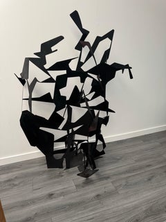A large abstract metal garden sculpture by Gerard Coquelin