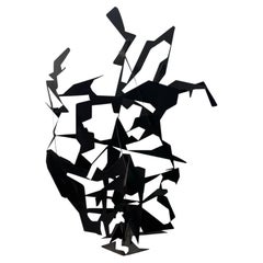 A large abstract metal garden sculpture by Gerard Coquelin