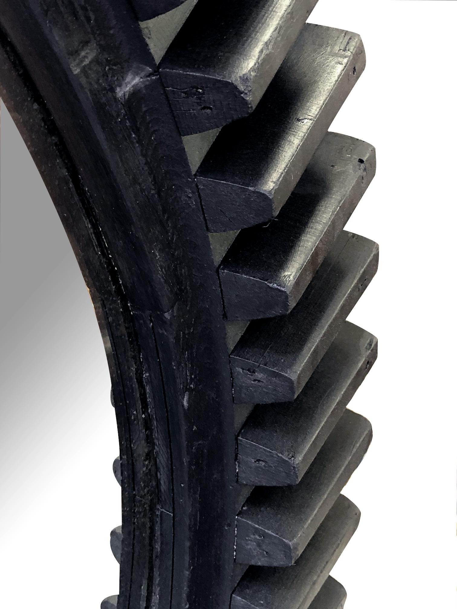 the thick ebonized gear wheel with cut teeth meant to mesh with another toothed wheel; fitted with a later mirror plate.