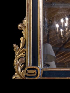 A Large and Boldly Carved Spanish Parcel Gilt and Ebonised Over Mantel Mirror