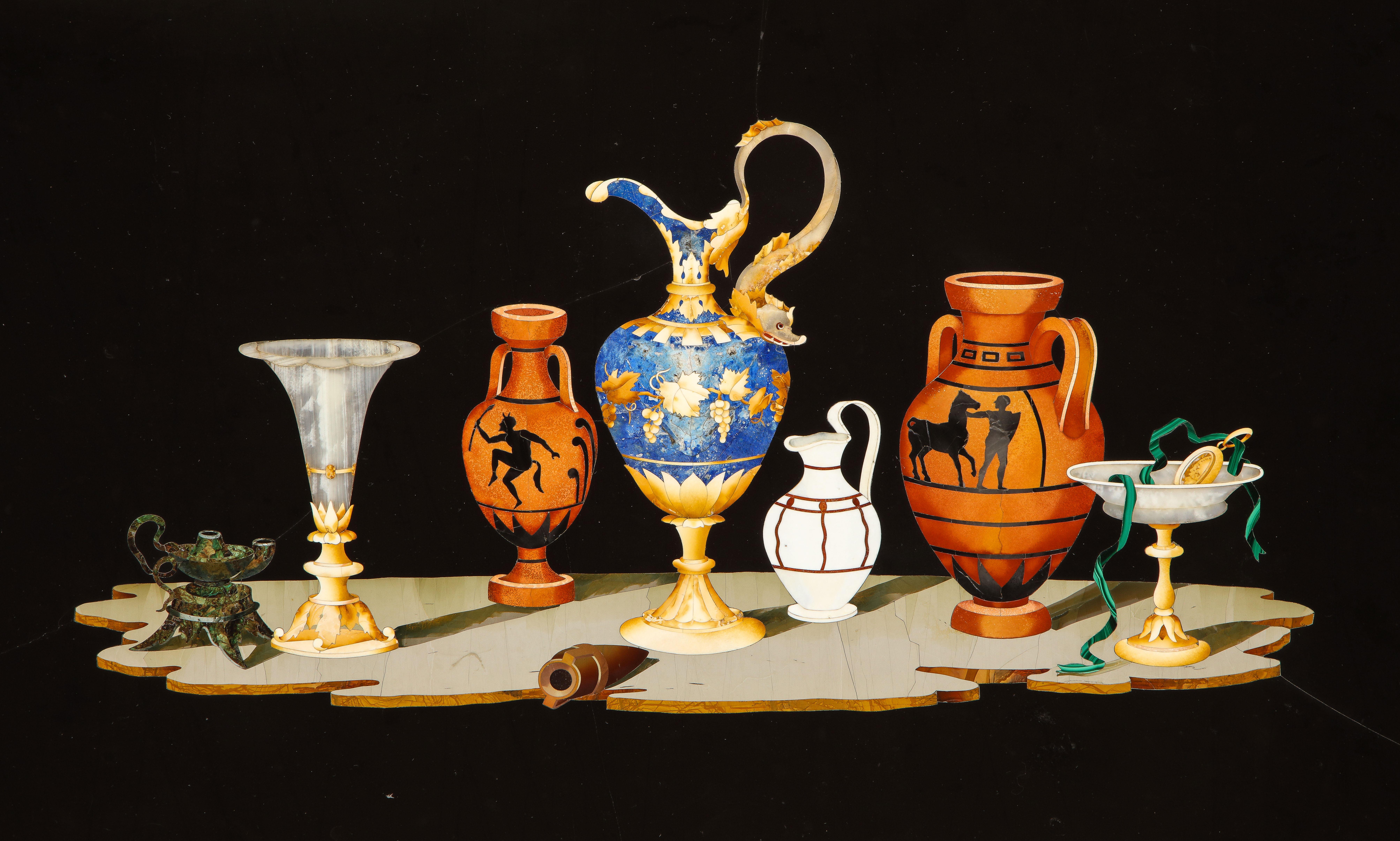 A Large and Fine Quality 19th Century Italian Pietra Dura Still-Life Framed Panel. The panel is an inlaid pietra dura composition set within a giltwood frame. It features a polished black stone background with an arrangement of classical vessels and