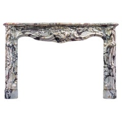 A Large and Grand Louis XV Rococo Breche Violette Fireplace