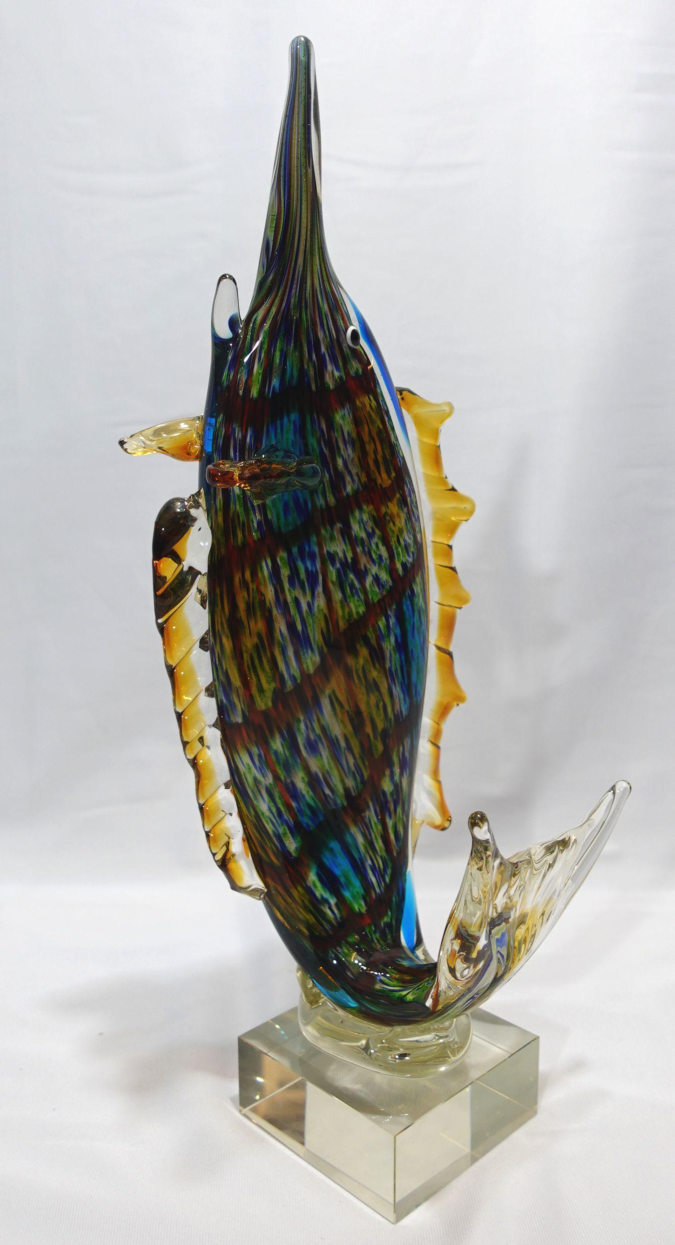 A Large and Heavy Murano Style Art Glass SailFish with many vivid colors applied on the body and set on a square clear glass, a very charming piece.