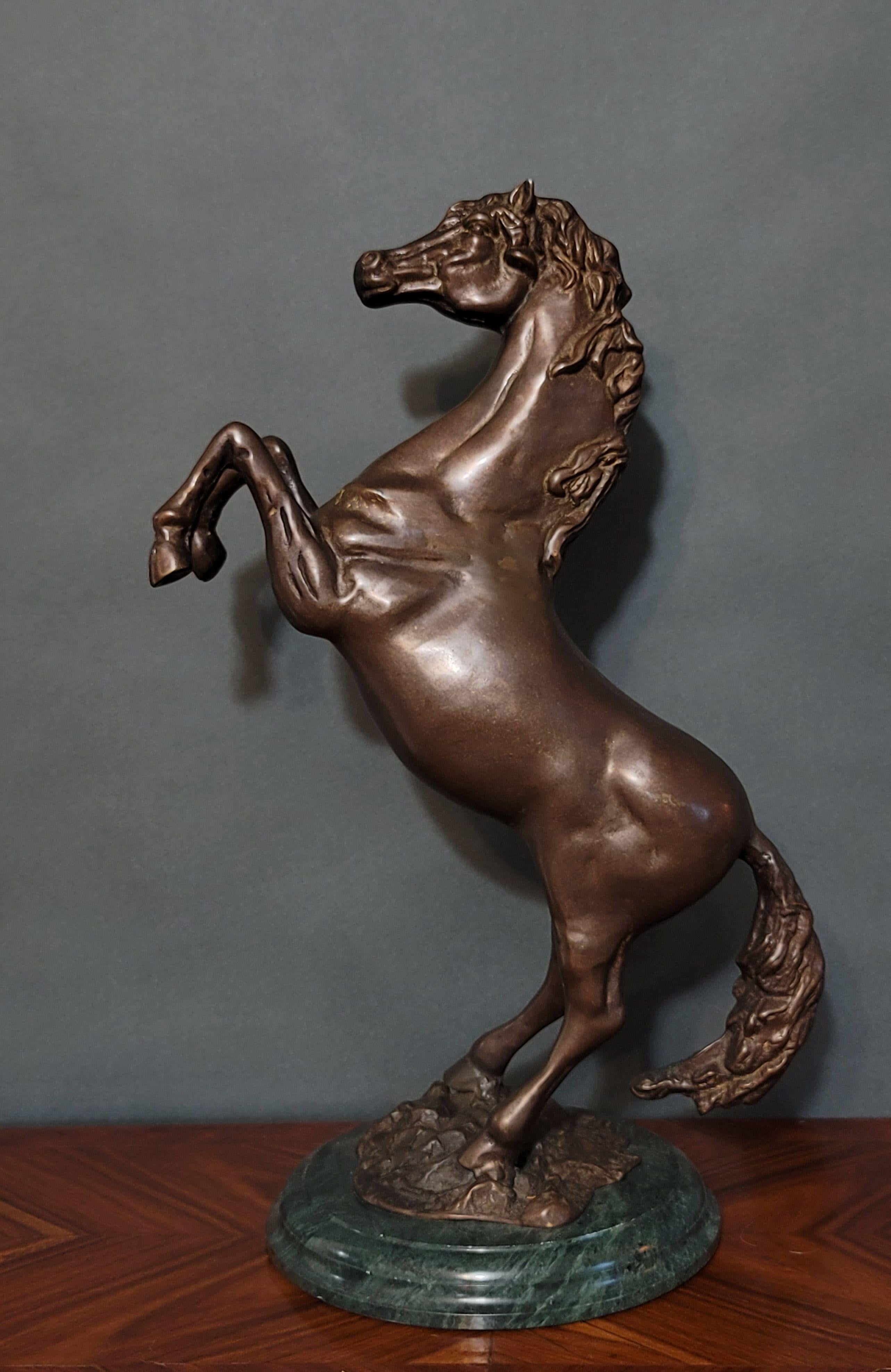 United States, 20th Century
Depicts a bucking horse with a flowing mane and tail-mounted on a round green marble base.





 