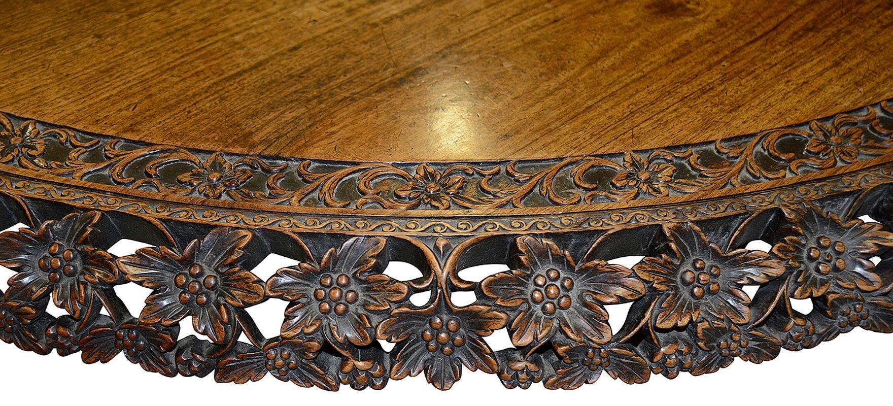 An Anglo-Indian hardwood circular centre table the base profusely carved with vines and leaves.