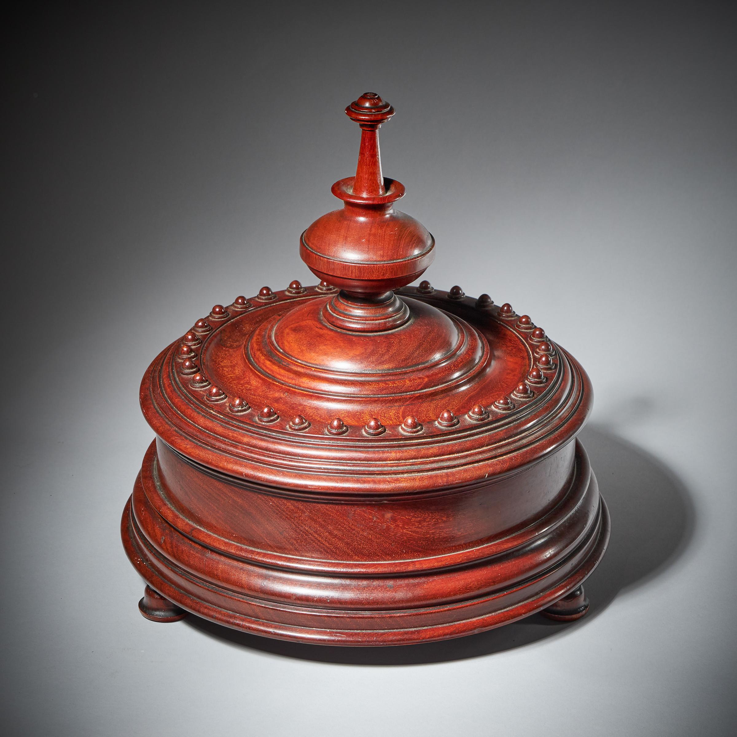 A good and impressively sized mid 19th Century finely turned Mahogany tobacco box with intricately turned lid.

This most decorative and unusual piece is raised on three bun feet turned moulded frieze, surmounted by an intricately turned finial